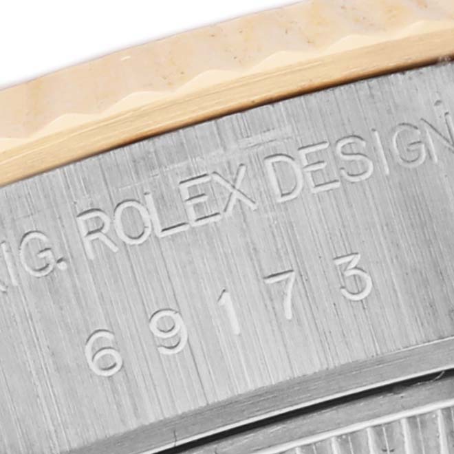 The image shows a close-up of the side engraving on a Rolex Datejust 69173 Women's Steel and Gold (two tone) White Dial 69173 Women's Steel and Gold (two tone) White Dial watch case, displaying the model number.