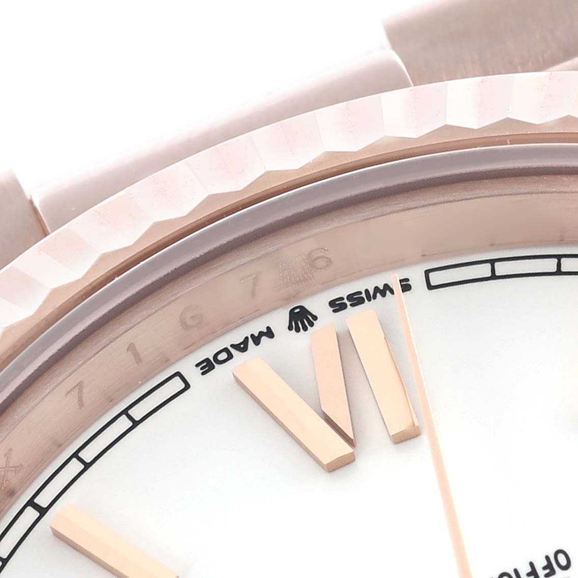 The image shows the bezel, part of the dial, and hour markers of a Rolex President 228235 Men's Rose Gold White Dial 228235 Men's Rose Gold White Dial model.