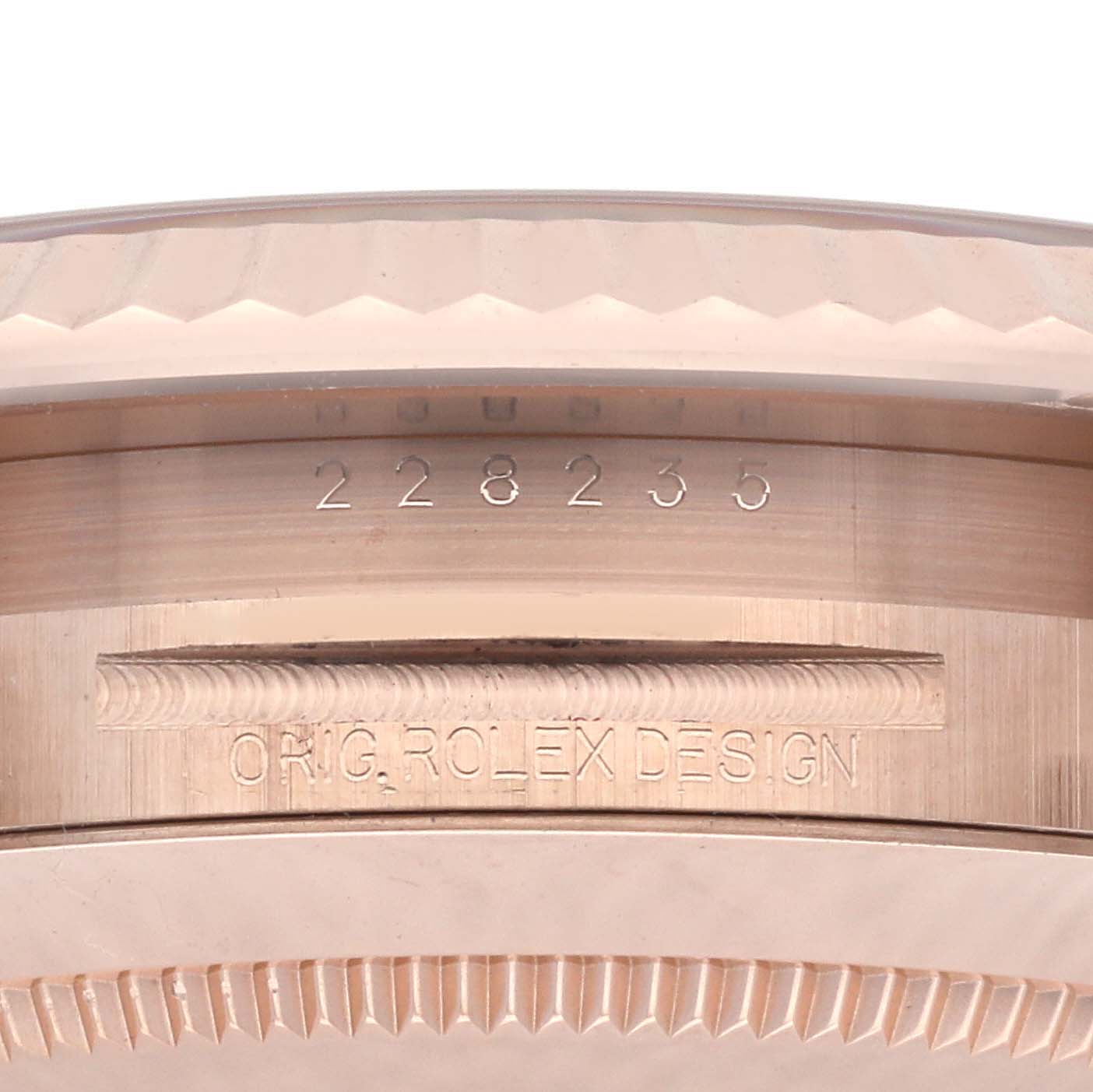 The image shows the side profile of a Rolex President 228235 Men's Rose Gold White Dial 228235 Men's Rose Gold White Dial watch, highlighting the engraved bezel and serial number.