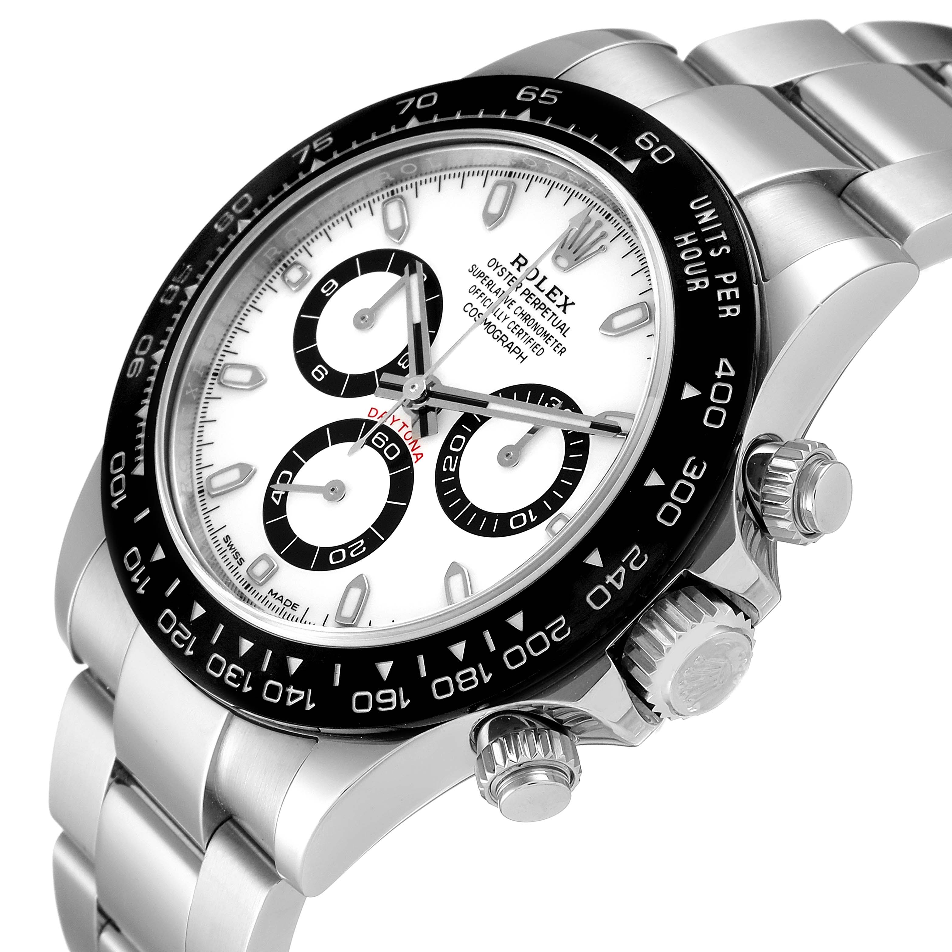 The image shows a close-up of a Rolex Daytona 116500 Men's Stainless Steel White Dial 116500 Men's Stainless Steel White Dial watch, highlighting the dial, bezel, and pushers from a slight angle.