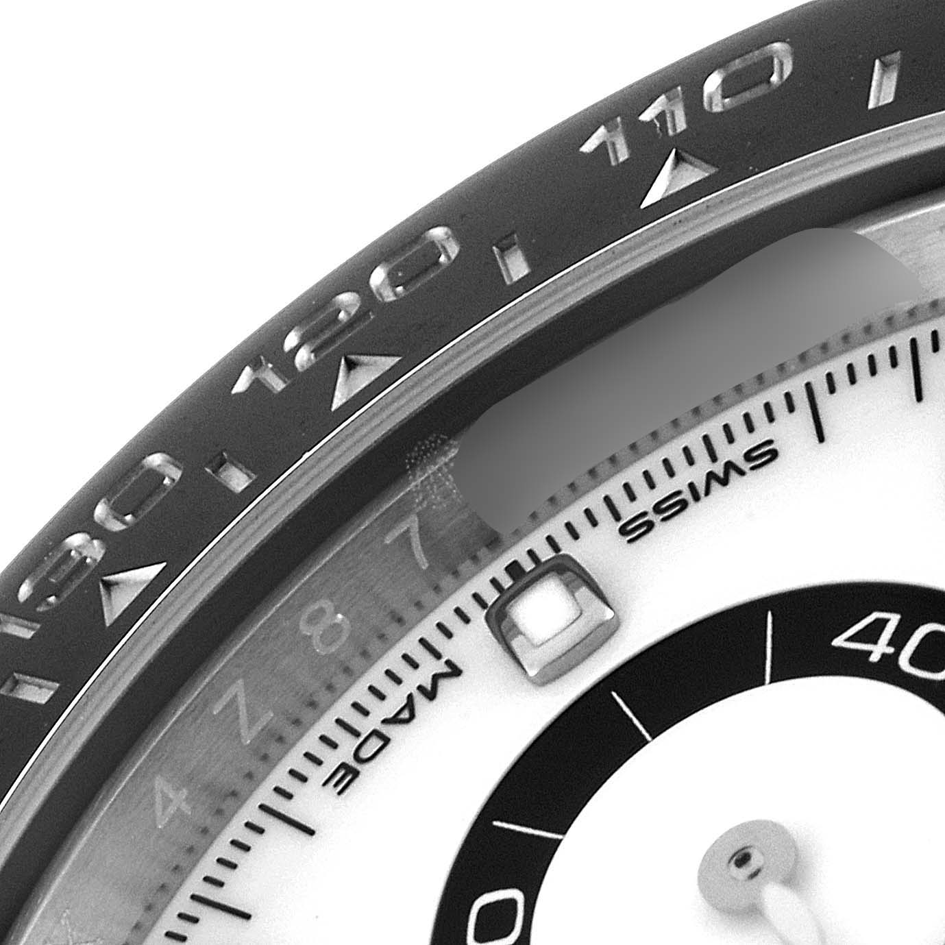 The image shows a close-up of the bezel, dial, and part of the subdial of a Rolex Daytona 116500 Men's Stainless Steel White Dial 116500 Men's Stainless Steel White Dial watch.