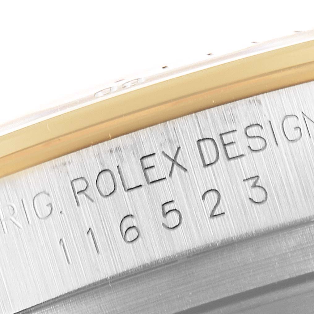 This image shows a close-up of the engraved serial number and model details on the side of a Rolex Daytona 16523 Men's Steel and Gold (two tone) Grey Dial 16523 Men's Steel and Gold (two tone) Grey Dial watch case.