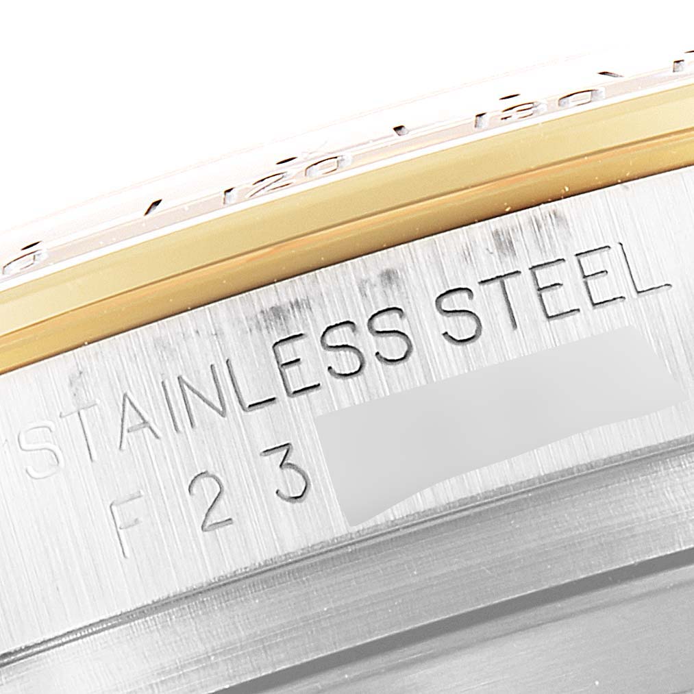 This image shows a close-up of the side of a Rolex Daytona 16523 Men's Steel and Gold (two tone) Grey Dial 16523 Men's Steel and Gold (two tone) Grey Dial watch, highlighting the "Stainless Steel" engraving.
