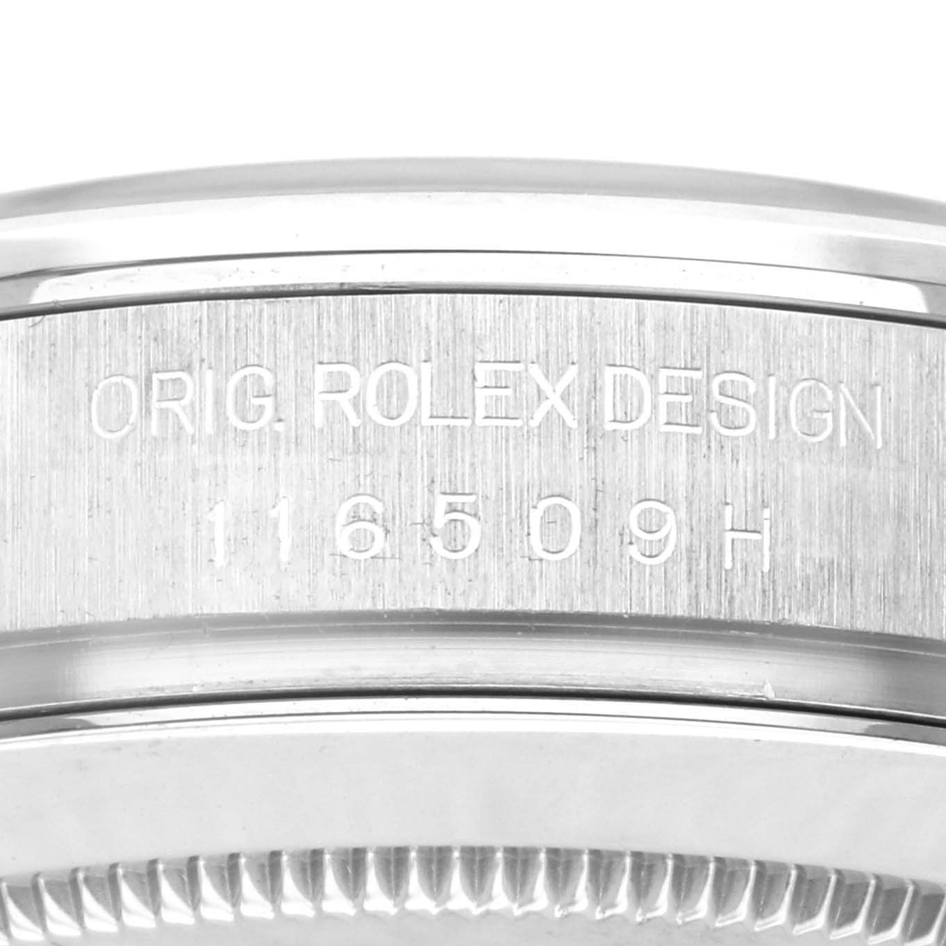 The image shows the side engraving of a Rolex Daytona 116509 Men
s White Gold Grey Dial 116509 Men
s White Gold Grey Dial, displaying "ORIG ROLEX DESIGN" and the model number 116509H.