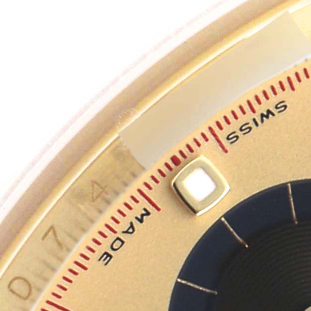 The close-up shows part of the bezel and dial details of a Rolex Daytona 116518 Men's Yellow Gold Champagne Dial, including part of the "Swiss Made" text.