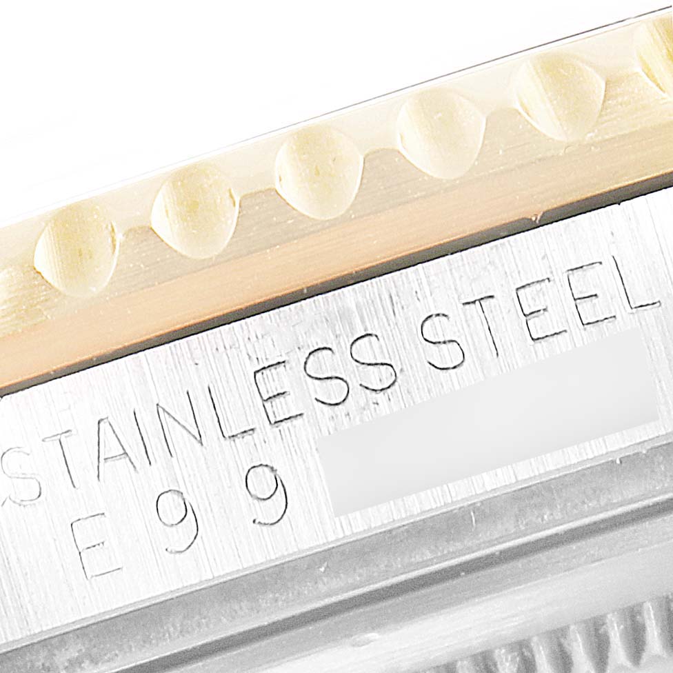 This image shows a close-up of the stainless steel side and part of the bezel of a Rolex GMT-Master 16713 Men's Steel and Gold (two tone) Black Dial 16713 Men's Steel and Gold (two tone) Black Dial watch.