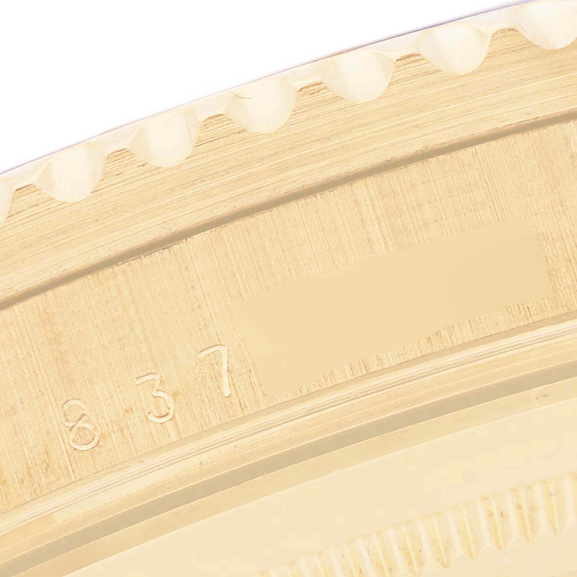 The image shows a close-up of the case edge with engravings on the Rolex GMT-Master 16758 Men's Yellow Gold Brown Dial 16758 Men's Yellow Gold Brown Dial watch.