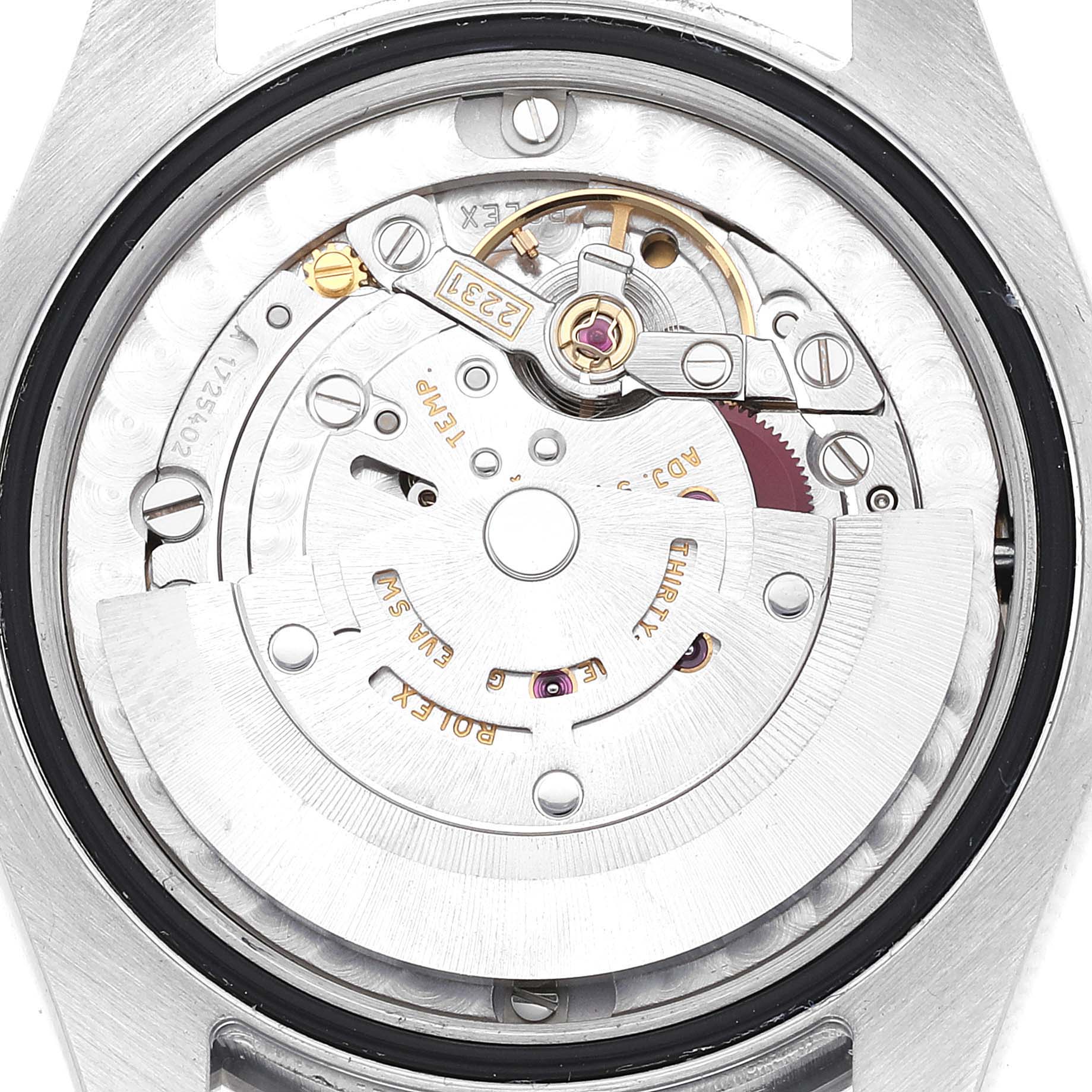 The image shows the internal mechanism of a Mid-Size Rolex watch viewed from the back, detailing the movement components.