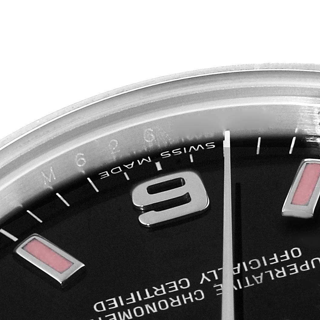This image shows a close-up of the dial, numbers, and part of the minute hand of a Mid-Size Rolex watch.