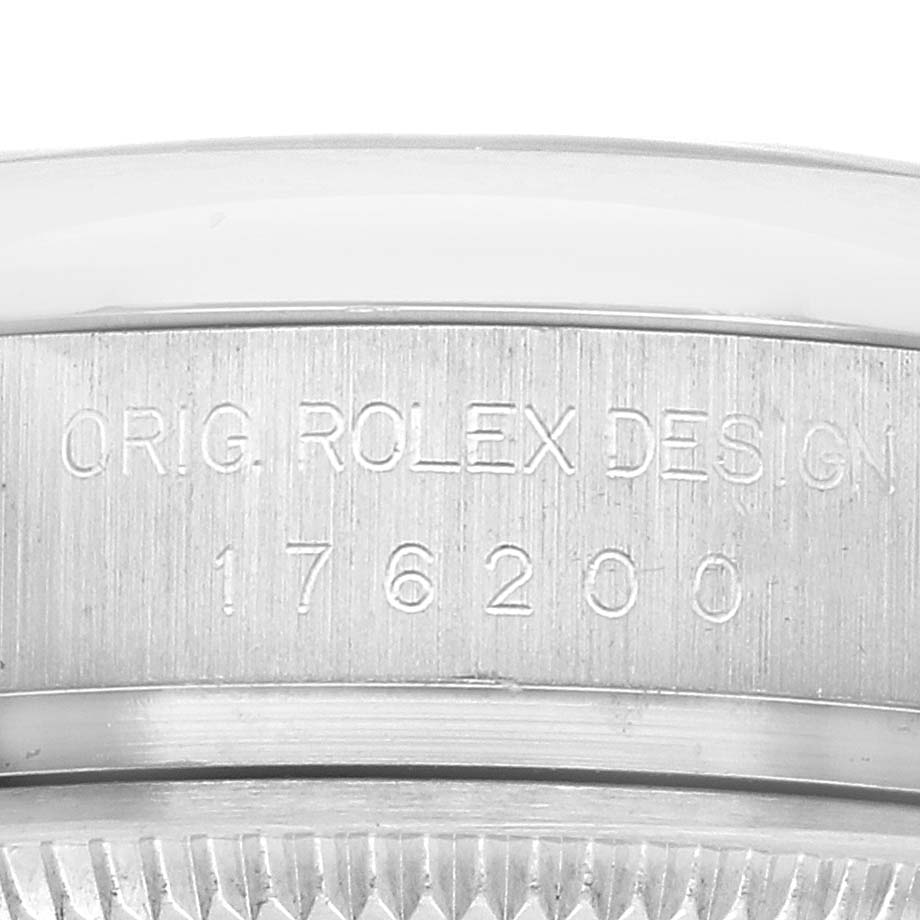 The image shows a close-up of the case side engraving on the Rolex Oyster Perpetual 176200 Women's Stainless Steel Silver Dial, displaying "ORIG. ROLEX DESIGN 176200."
