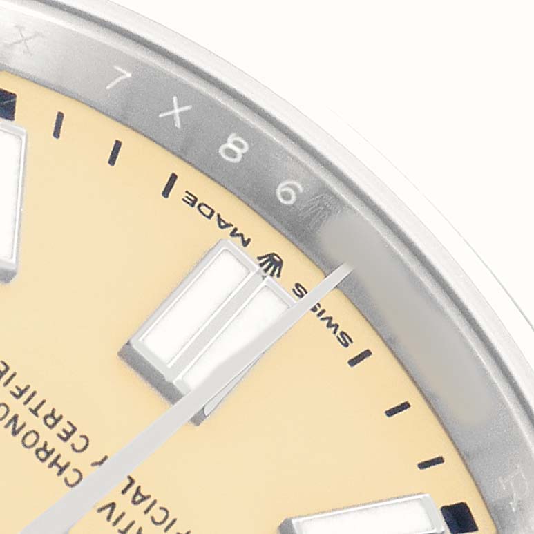 The image shows a close-up of the dial and hour markers of a Rolex Oyster Perpetual 134300 Men's Stainless Steel Beige Dial watch.