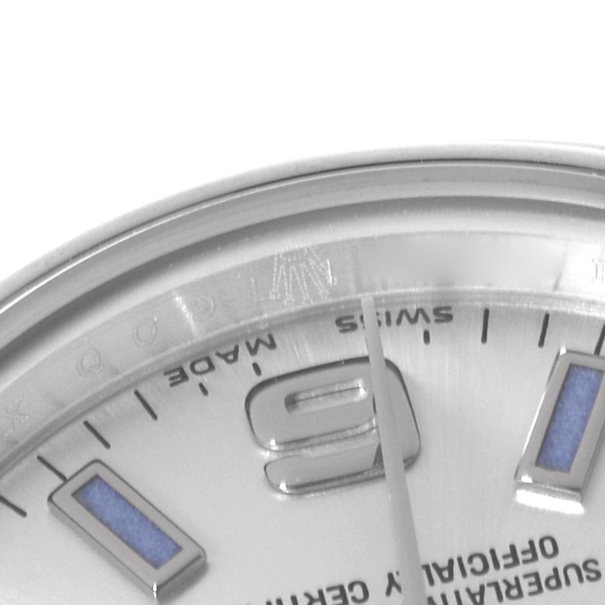 This image shows a close-up angle of a Rolex Oyster Perpetual 176200 Women
s Stainless Steel Silver Dial 176200 Women
s Stainless Steel Silver Dial watch, focusing on part of the dial, bezel, and hour markers.