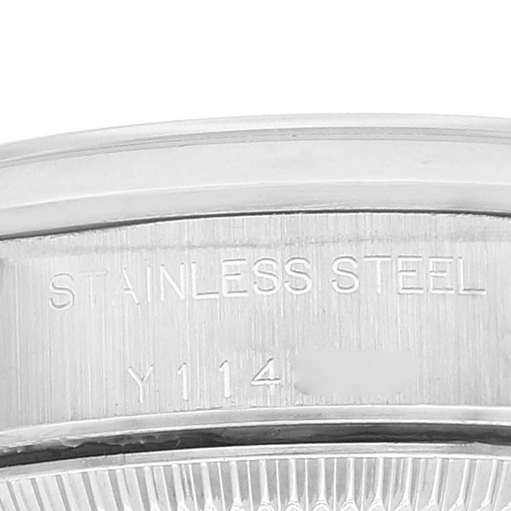 This close-up image shows the case side of a Rolex Oyster Perpetual 76080 Women
s Stainless Steel Silver Dial 76080 Women
s Stainless Steel Silver Dial watch, highlighting the "STAINLESS STEEL" engraving.