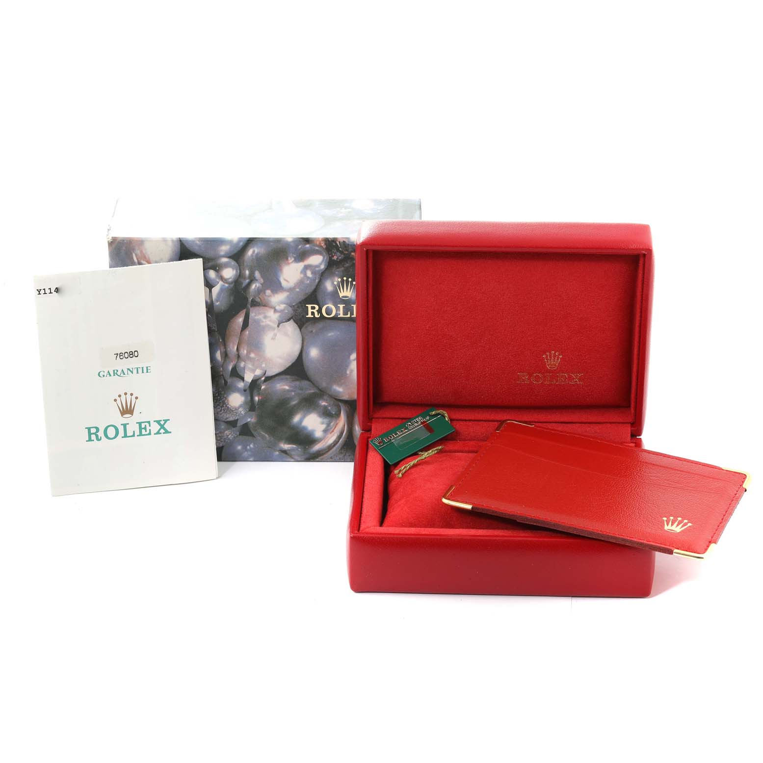This image shows the packaging accessories of a Rolex Oyster Perpetual 76080 Women
s Stainless Steel Silver Dial 76080 Women
s Stainless Steel Silver Dial, including the box, booklet, and guarantee card holder.