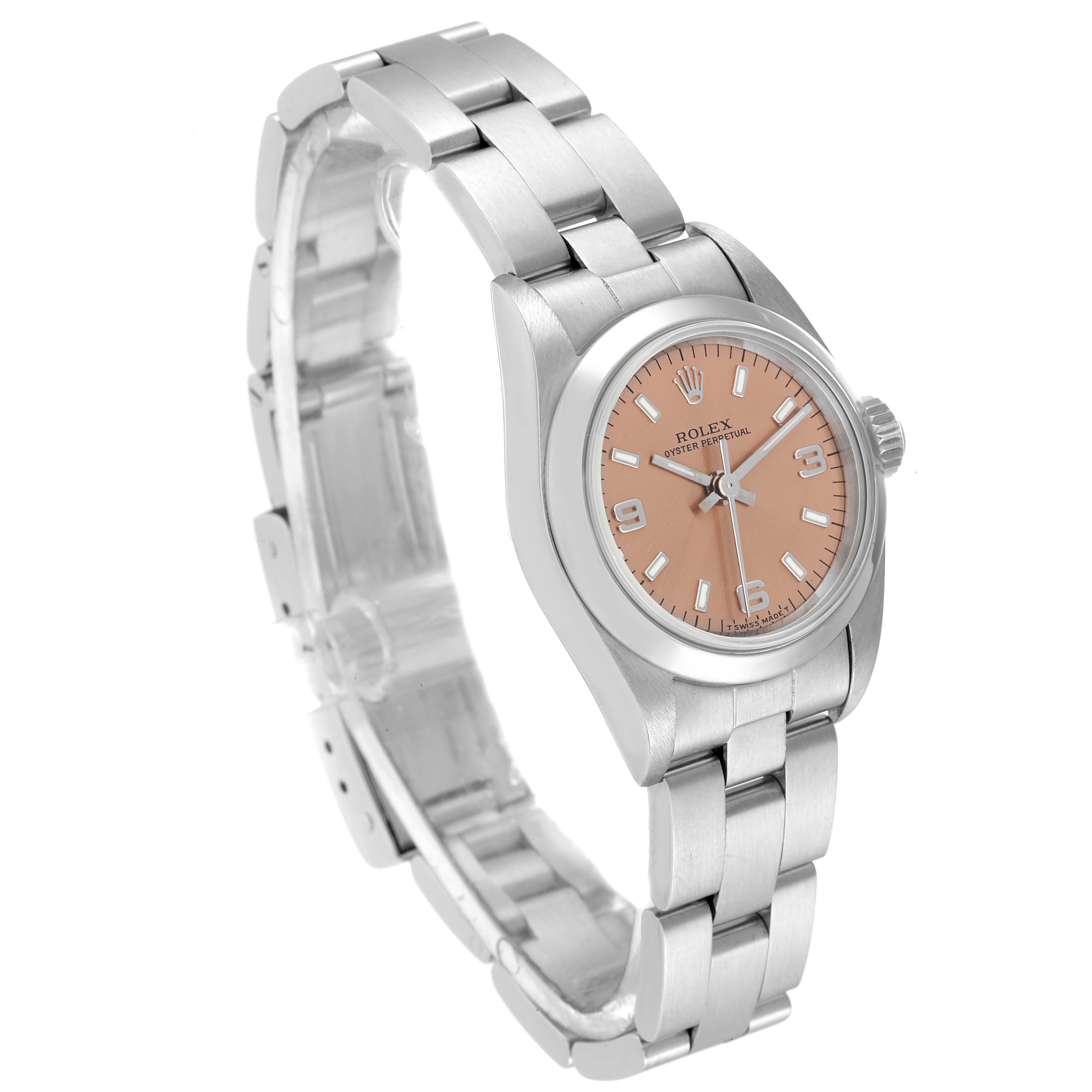 The Rolex Oyster Perpetual 67180 Women
s Stainless Steel Pink Dial 67180 Women
s Stainless Steel Pink Dial watch is shown at a slight angle, displaying its bracelet, case, and rose-colored dial.