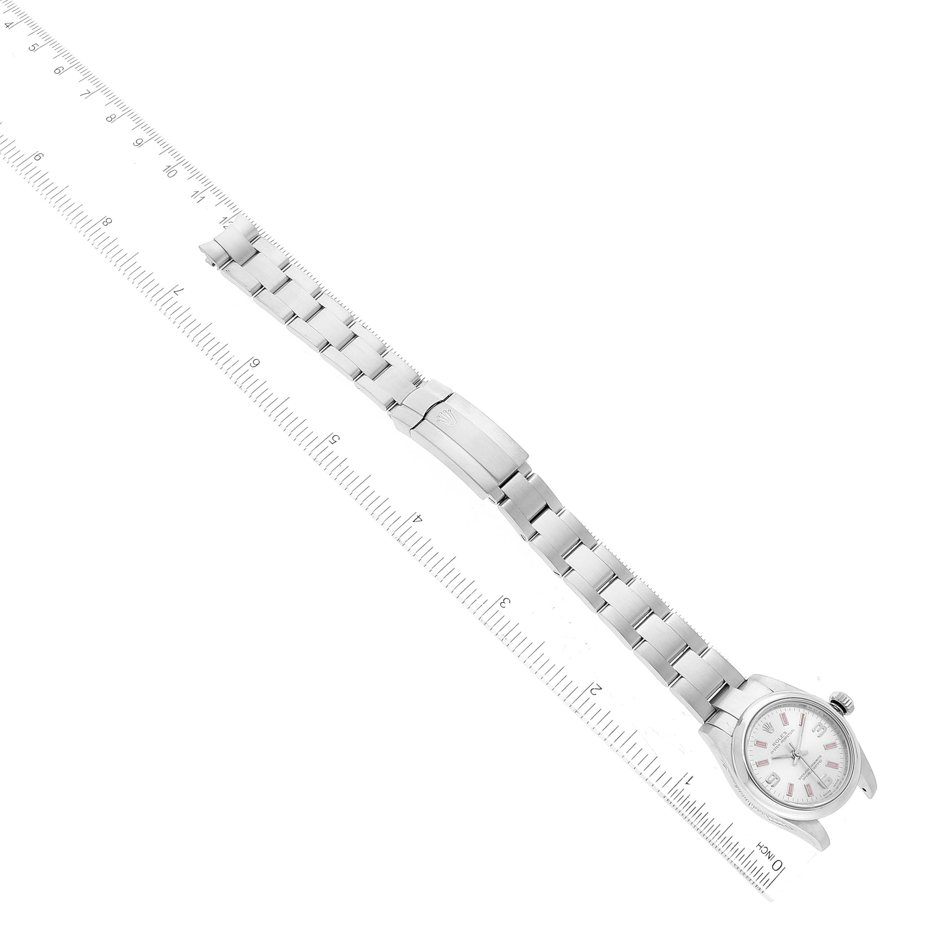 This image shows a full view of a Rolex Oyster Perpetual 176200 Women's Stainless Steel Silver Dial 176200 Women's Stainless Steel Silver Dial watch, including its bracelet and clasp, along with a ruler for scale.
