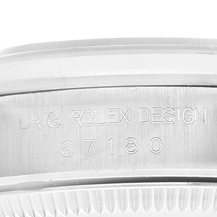 This image shows a close-up of the side engraving and bezel of a Rolex Oyster Perpetual 67180 Women's Stainless Steel Black Dial 67180 Women's Stainless Steel Black Dial watch, displaying the model number and design marking.