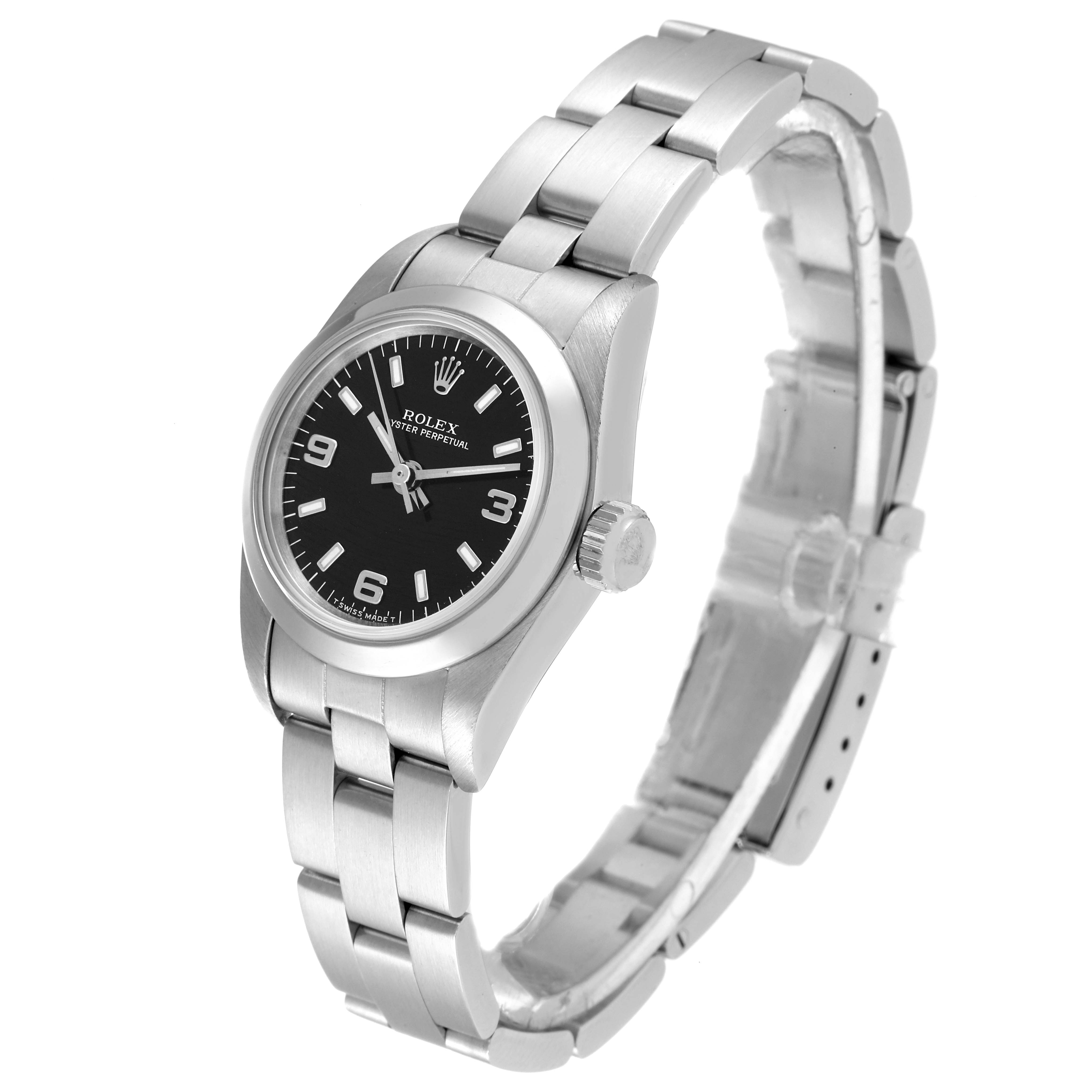 The image shows an angled view of a Rolex Oyster Perpetual 67180 Women's Stainless Steel Black Dial 67180 Women's Stainless Steel Black Dial watch, highlighting its dial, bezel, crown, and metallic bracelet.