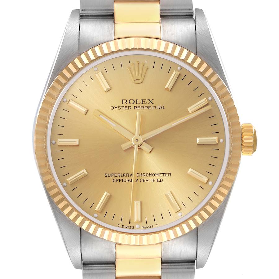 The Rolex Oyster Perpetual watch is shown from the front, highlighting its gold dial, bezel, and two-tone bracelet.