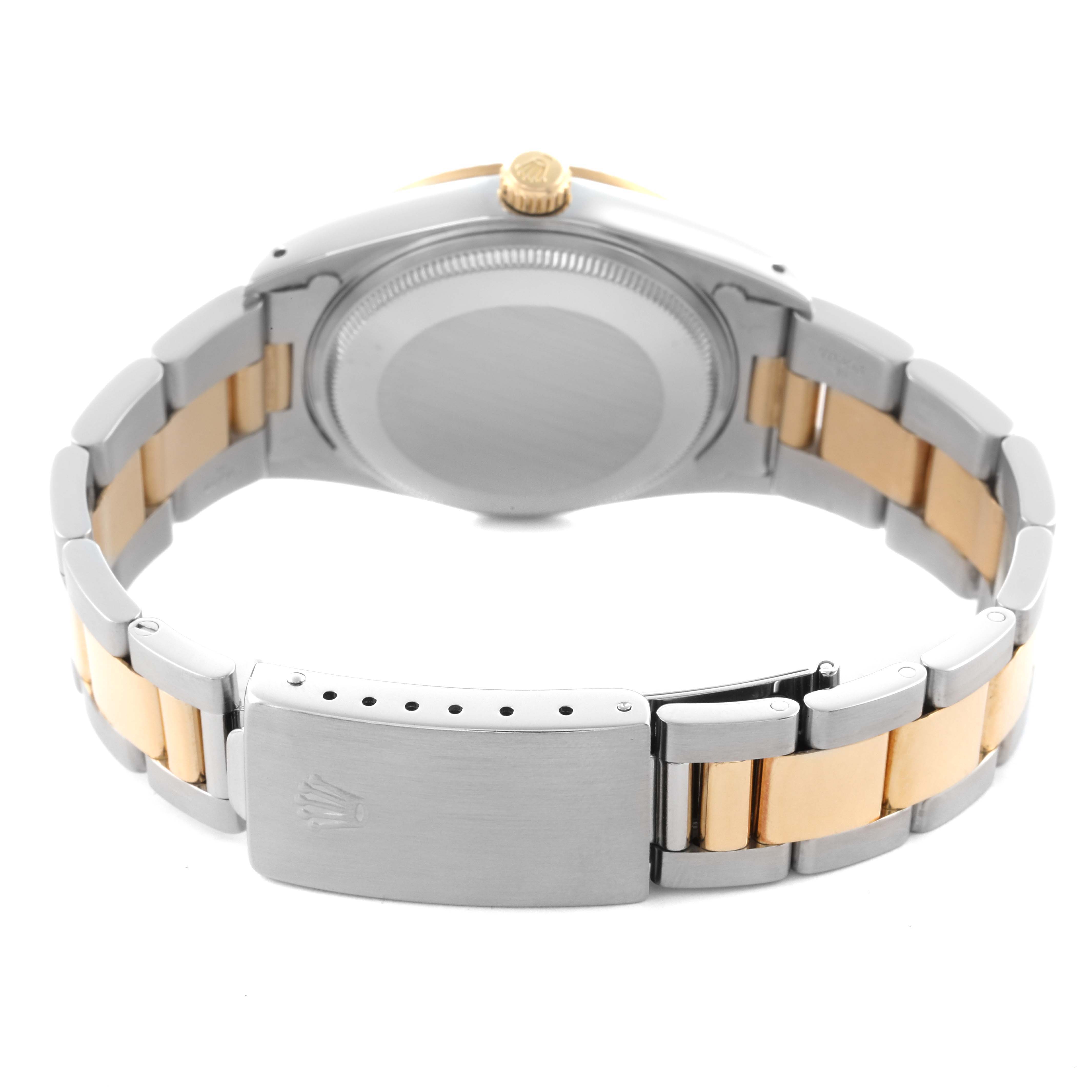 The image shows the back view of a Rolex Oyster Perpetual 14233 Men's Steel and Gold (two tone) Champagne Dial 14233 Men's Steel and Gold (two tone) Champagne Dial, highlighting its clasp, bracelet, and case.