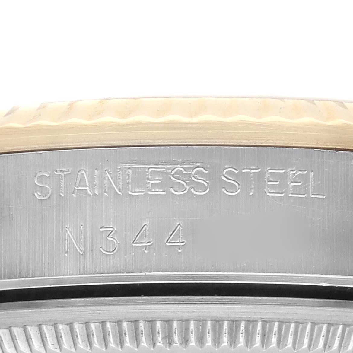 This image shows a close-up of the case edge with engraving on a Rolex Oyster Perpetual 14233 Men's Steel and Gold (two tone) Champagne Dial 14233 Men's Steel and Gold (two tone) Champagne Dial watch.