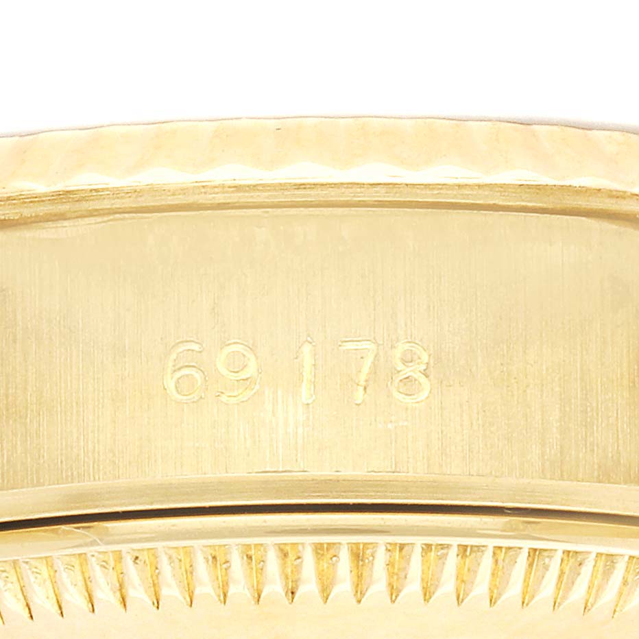 The image shows a close-up of the side casing of a Rolex President 69178 Women's Yellow Gold Black Dial watch, highlighting the reference number and fluted bezel.