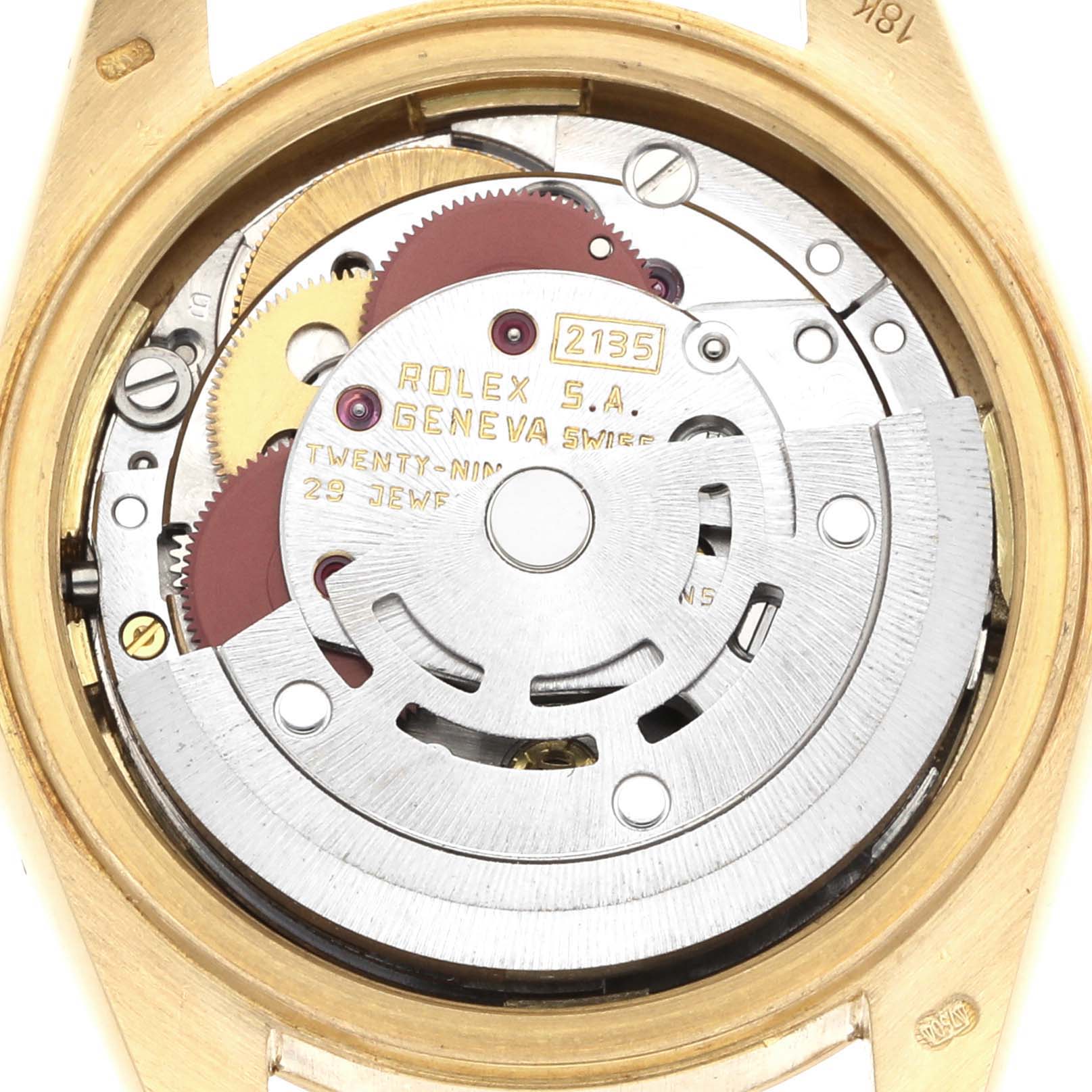 The image shows the movement of a Rolex President 69178 Women's Yellow Gold White Dial watch, visible through the open case back, highlighting its intricate components.