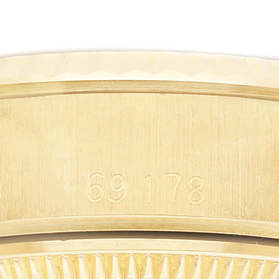 The image shows the side of the Rolex President 69178 Women's Yellow Gold White Dial model watch case, highlighting its serial number engraving.