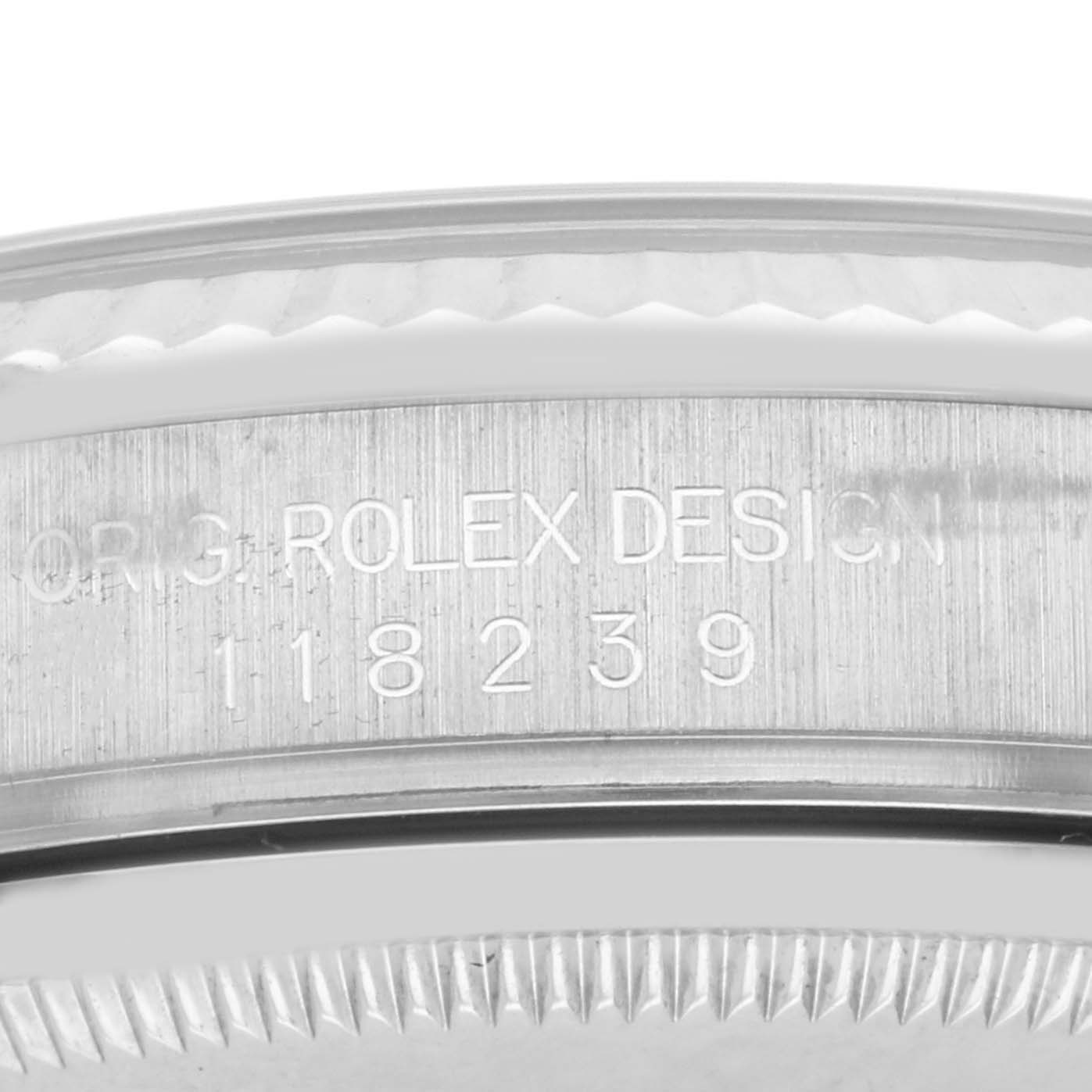 The image shows a close-up of the Rolex President 118239A Men's White Gold Silver Dial 118239A Men's White Gold Silver Dial model's case side with engraved details.