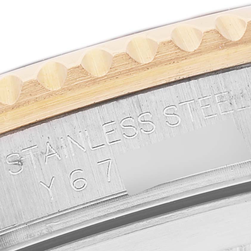 The image shows a close-up of the side of a Rolex Submariner 16613 Men's Steel and Gold (two tone) Blue Dial 16613 Men's Steel and Gold (two tone) Blue Dial watch, focusing on the stainless steel part of the case and the bezel edge.