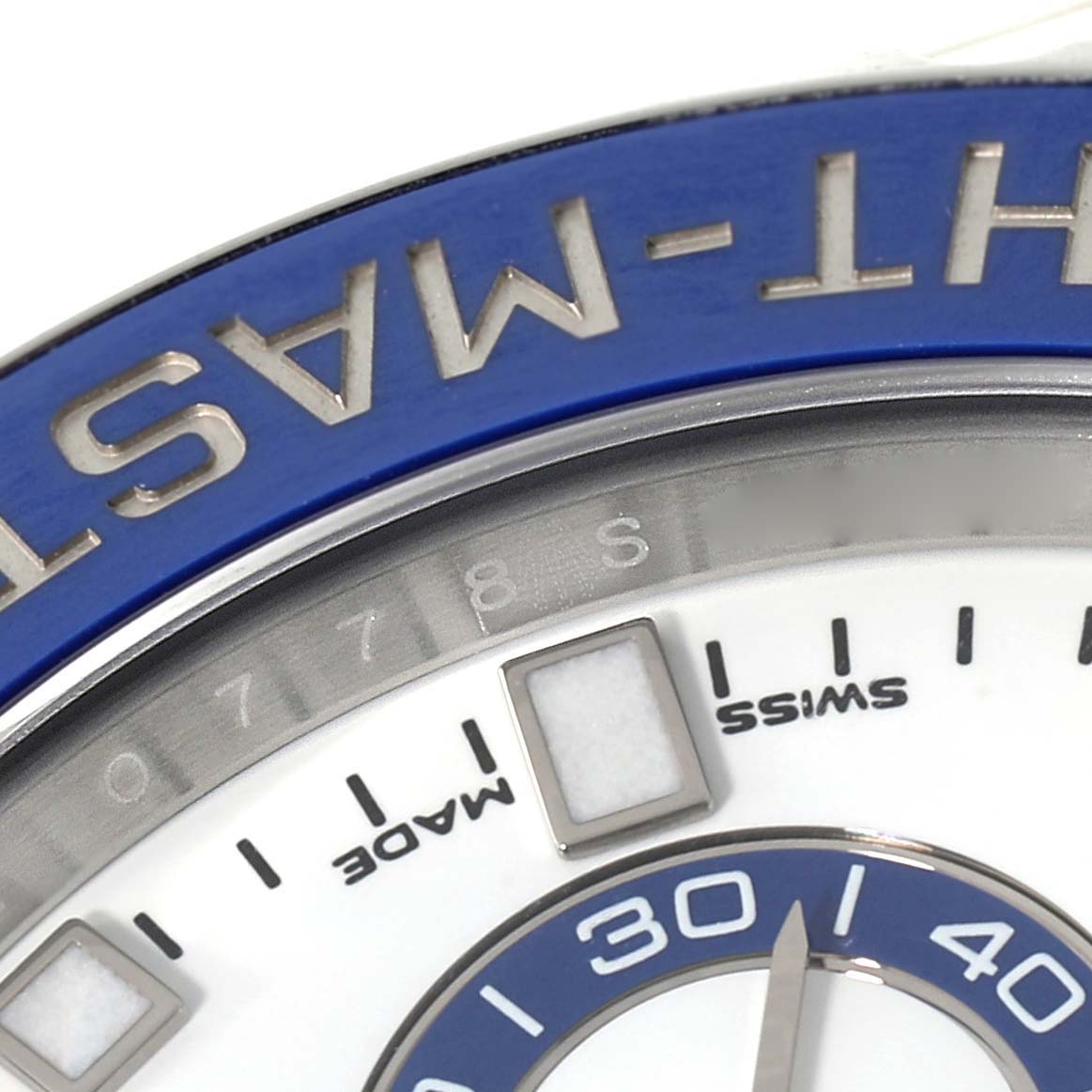 Close-up of the Rolex Yacht-Master 116680 Men's Stainless Steel White Dial 116680 Men's Stainless Steel White Dial watch showing part of the blue bezel and the 'Made' in 'SWISS MADE' markings on the dial.