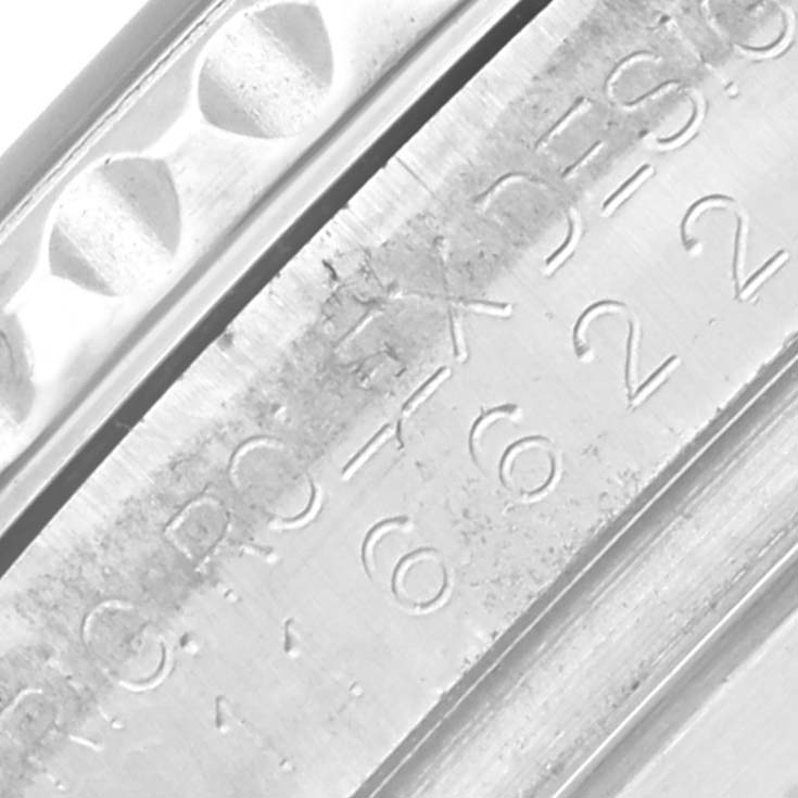 The image shows a close-up of the engraved case edge of a Rolex Yacht-Master 116622 Men's Stainless Steel Grey Dial 116622 Men's Stainless Steel Grey Dial.