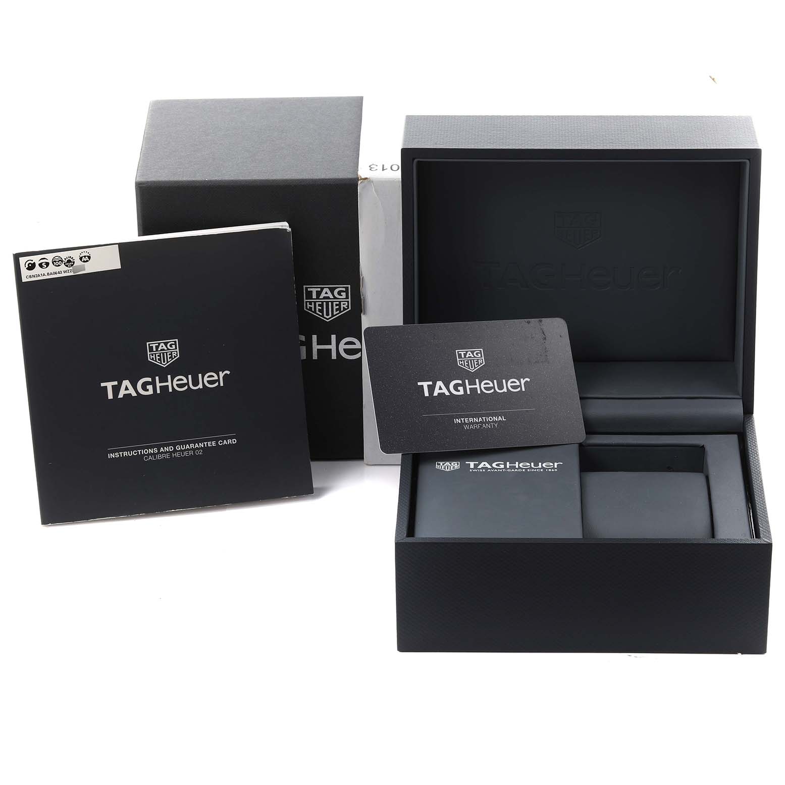 The image shows a Tag Heuer Carrera CBN2A1A Men's Stainless Steel Blue Dial CBN2A1A Men's Stainless Steel Blue Dial box, international warranty card, and instruction manual from a frontal angle.