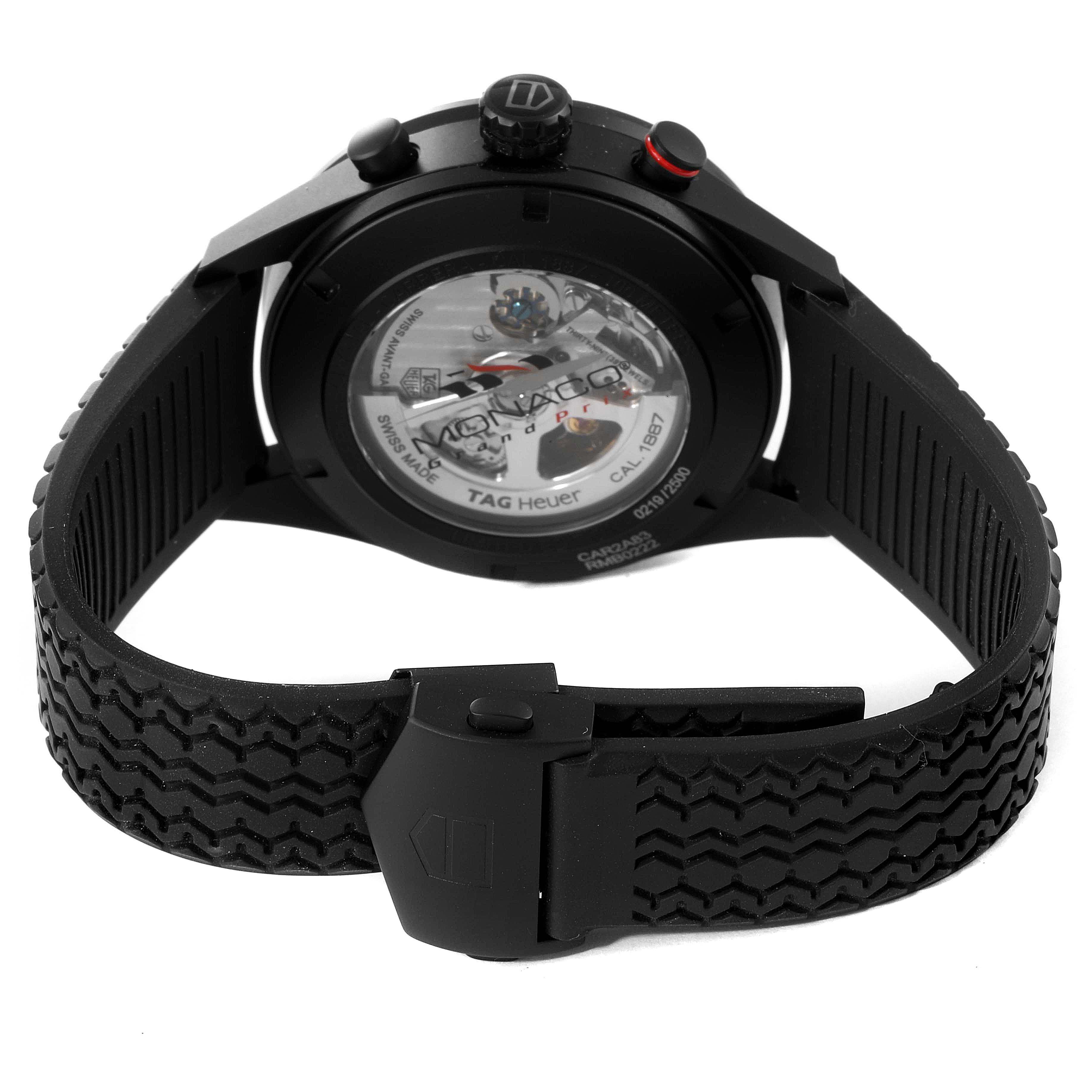 The image shows the back view of the Tag Heuer Monaco CAR2A83.FT6033 Men's Titanium Black Dial CAR2A83.FT6033 Men's Titanium Black Dial watch, highlighting its black rubber strap and visible automatic movement.