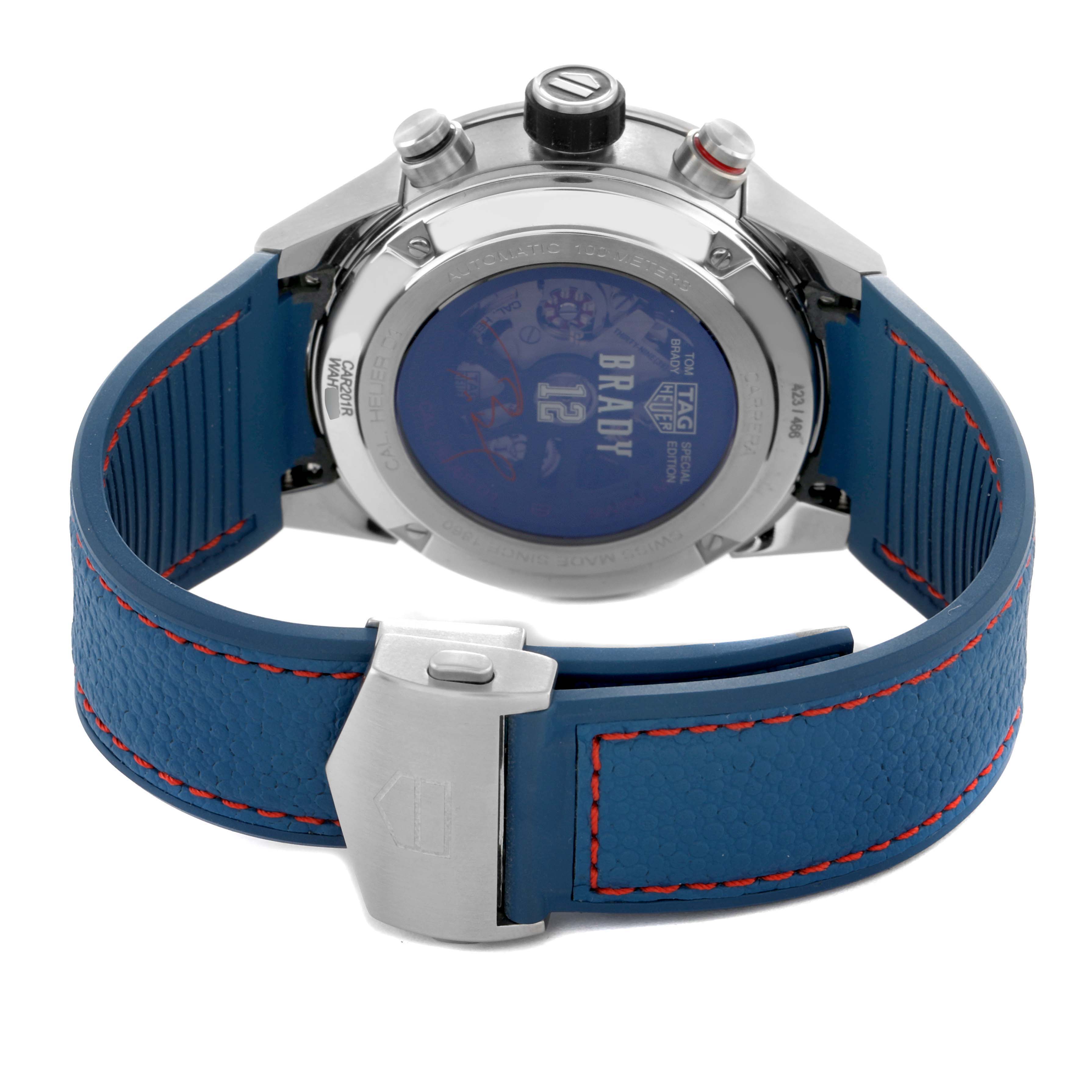 The image shows the back of a Tag Heuer Carrera CAR201R Men's Stainless Steel Blue Dial watch with a blue strap and visible clasp.