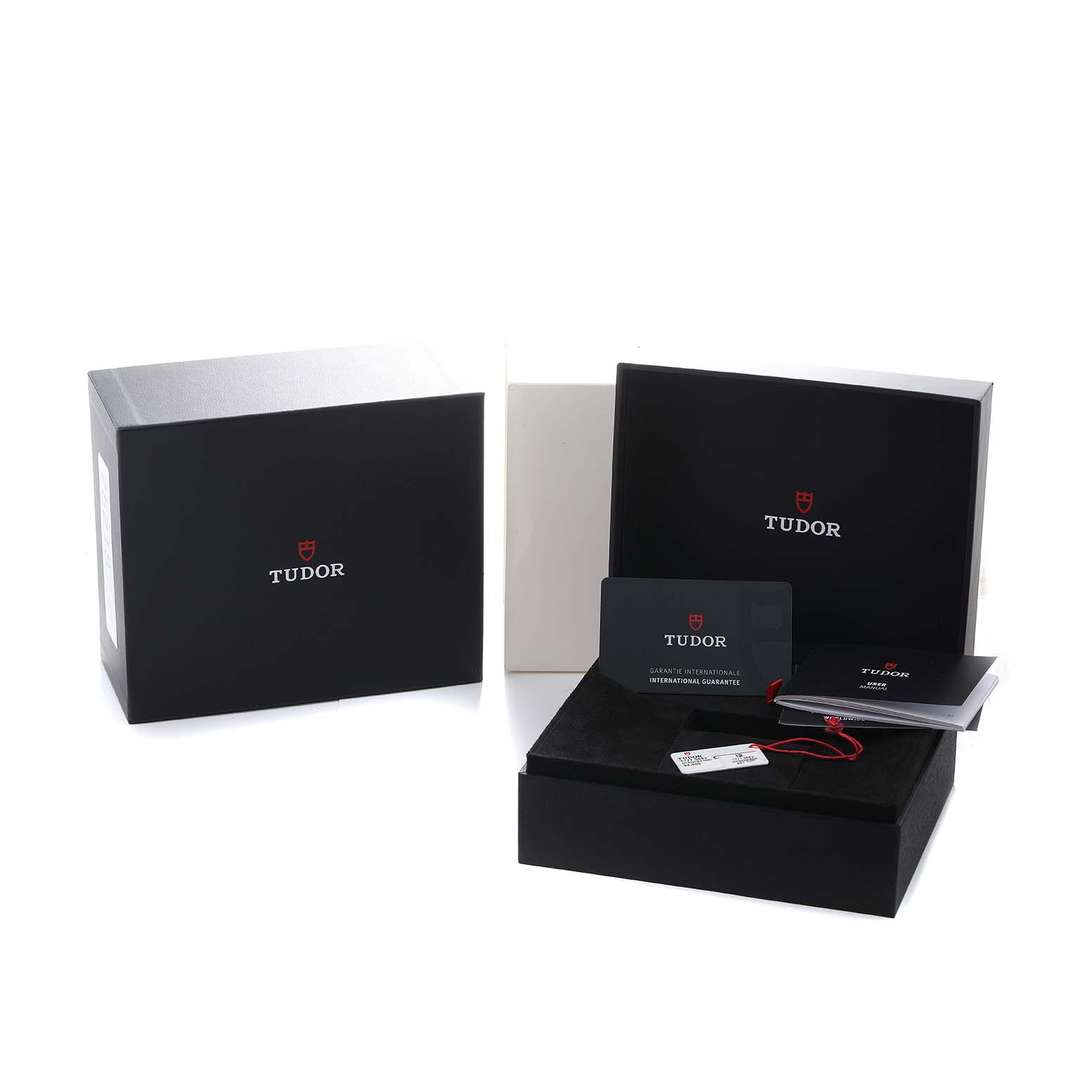 The image shows the Tudor Heritage Black Bay 79250 Men's Bronze Black Dial packaging, warranty card, and booklet at an angled view.