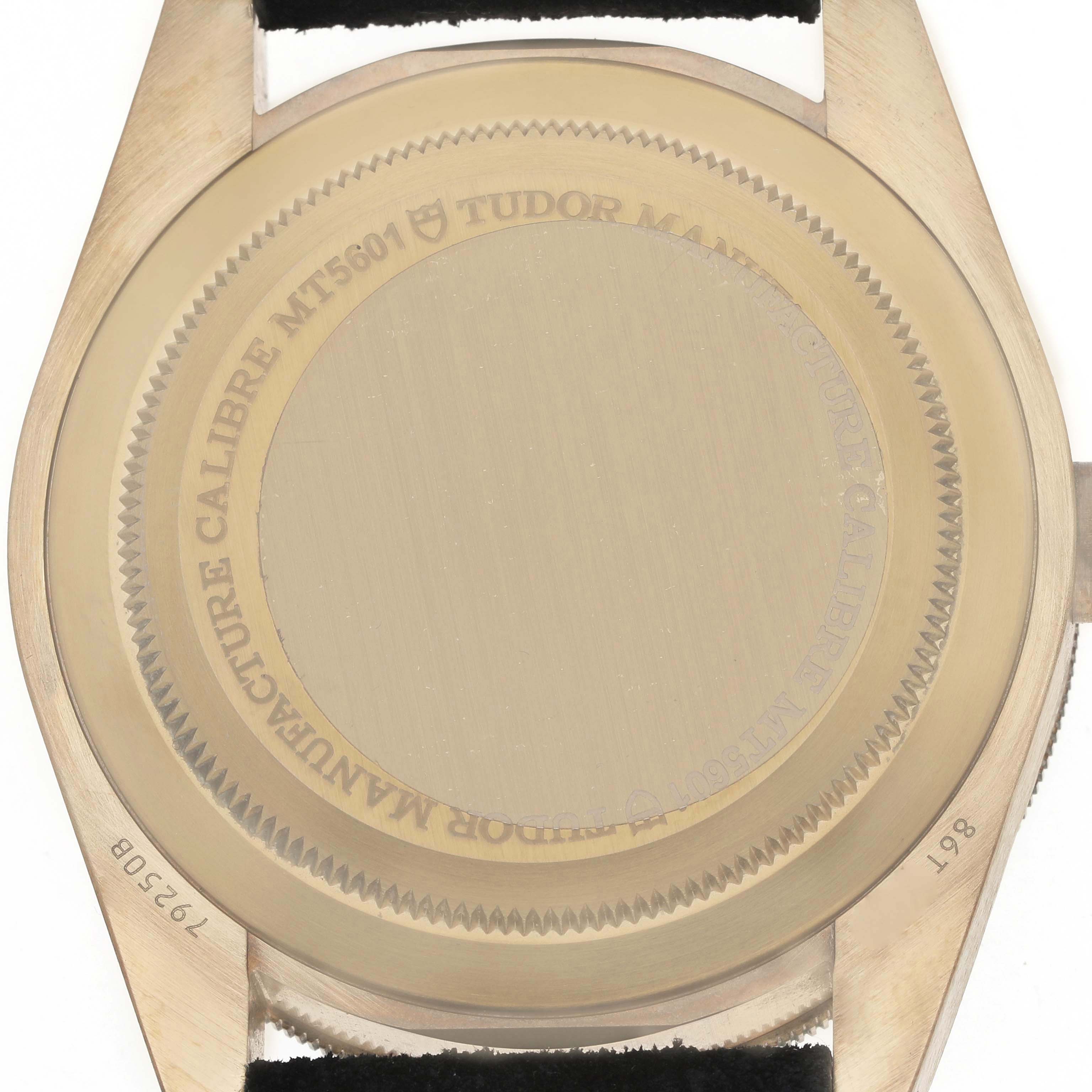 The image shows the back case of a Tudor Heritage Black Bay 79250 Men's Bronze Black Dial watch, showcasing the engraving details and model information.