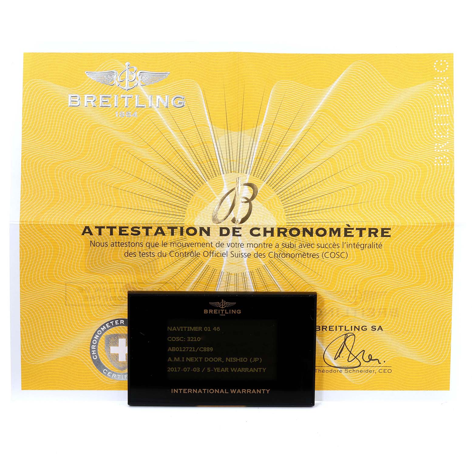 The image shows the certificate of chronometer for the Breitling Navitimer AB012721-C889-453A Men's Stainless Steel Blue Dial AB012721-C889-453A Men's Stainless Steel Blue Dial model and the international warranty card placed in front of it.