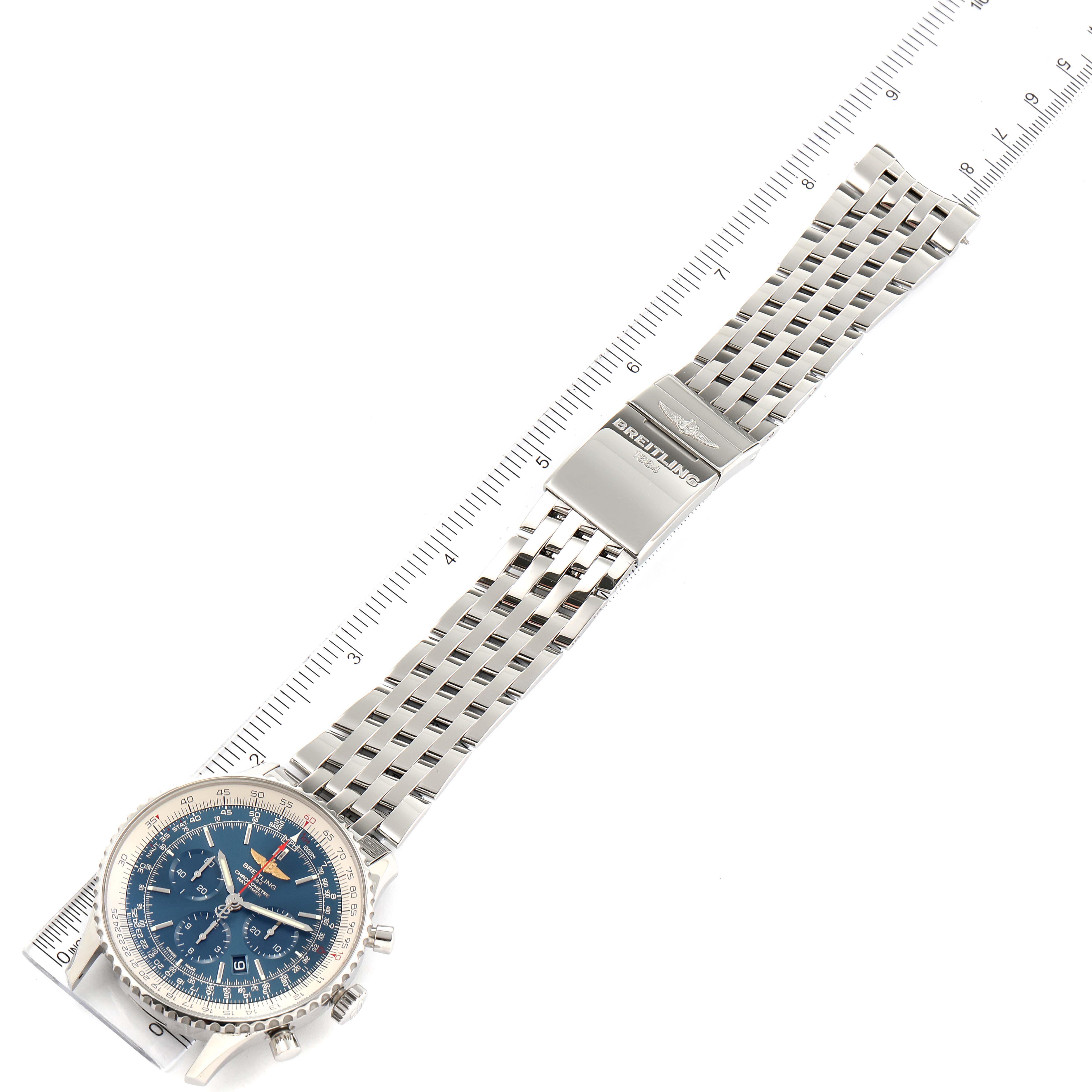 This top-down view shows the Breitling Navitimer AB012721-C889-453A Men's Stainless Steel Blue Dial AB012721-C889-453A Men's Stainless Steel Blue Dial watch with its face, bezel, and metal bracelet laid flat next to a ruler.