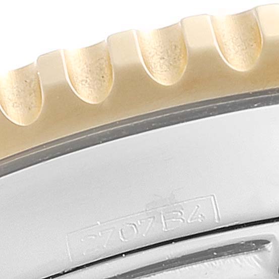 This close-up image shows the textured bezel and part of the casing of a Breitling Navitimer D23322 Men's Steel and Gold (two tone) Black Dial D23322 Men's Steel and Gold (two tone) Black Dial watch.