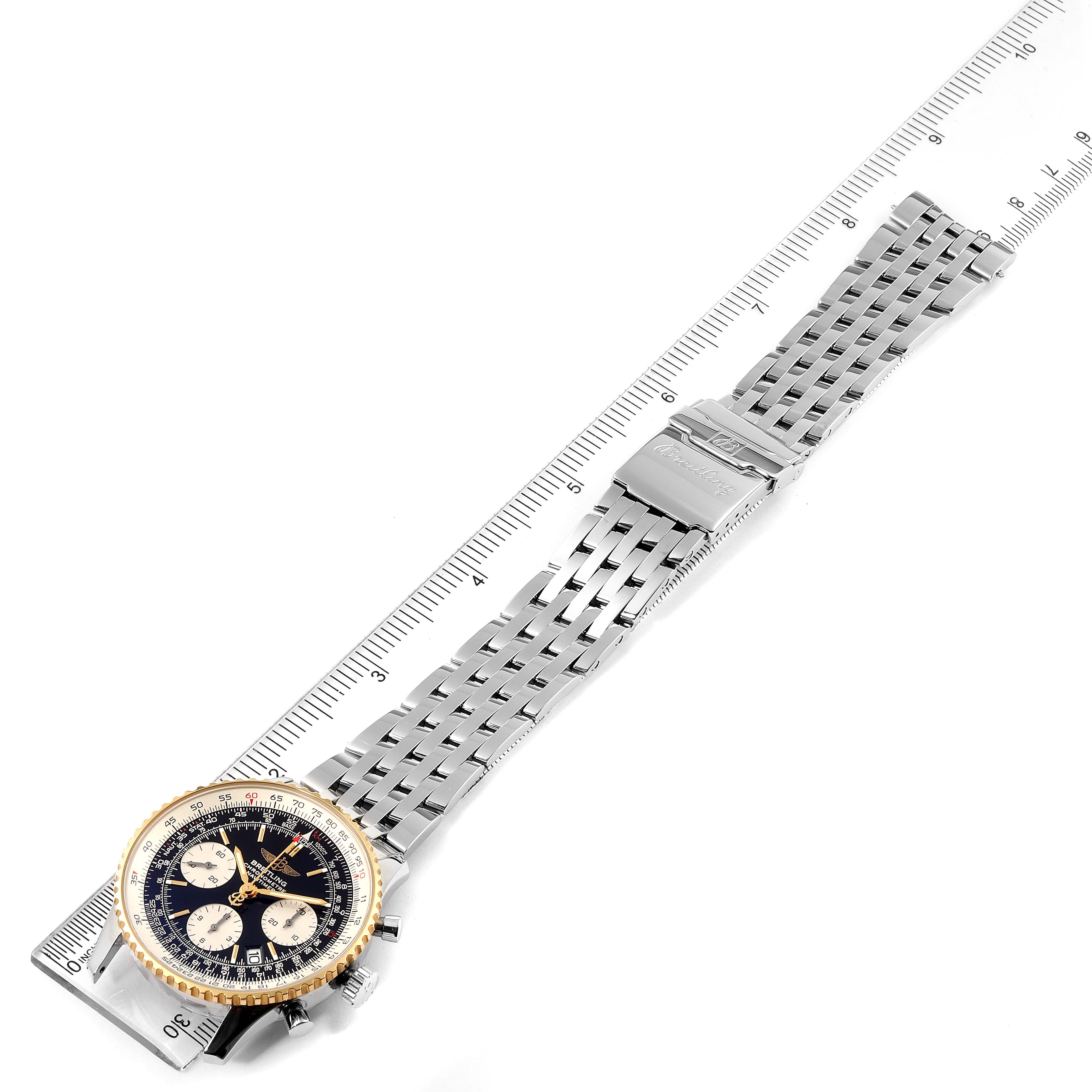 The image shows a top-down view of a Breitling Navitimer D23322 Men's Steel and Gold (two tone) Black Dial D23322 Men's Steel and Gold (two tone) Black Dial watch, including the face, bezel, and metal bracelet, laid next to a ruler.