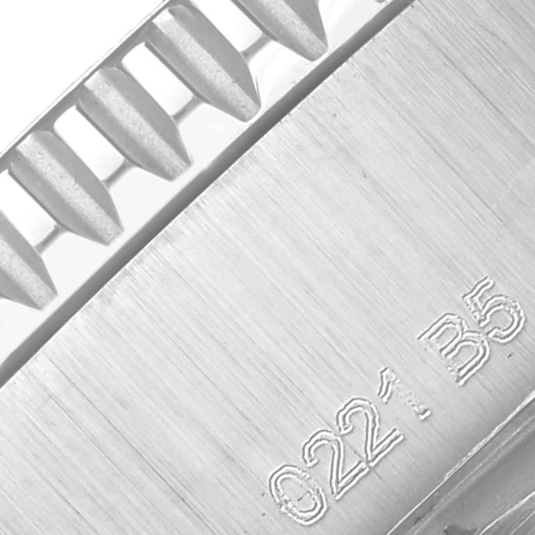 The image shows a close-up of the Breitling Superocean A17366 Men
s Stainless Steel White Dial A17366 Men
s Stainless Steel White Dial watch bezel with notched edge and engraved numbers.