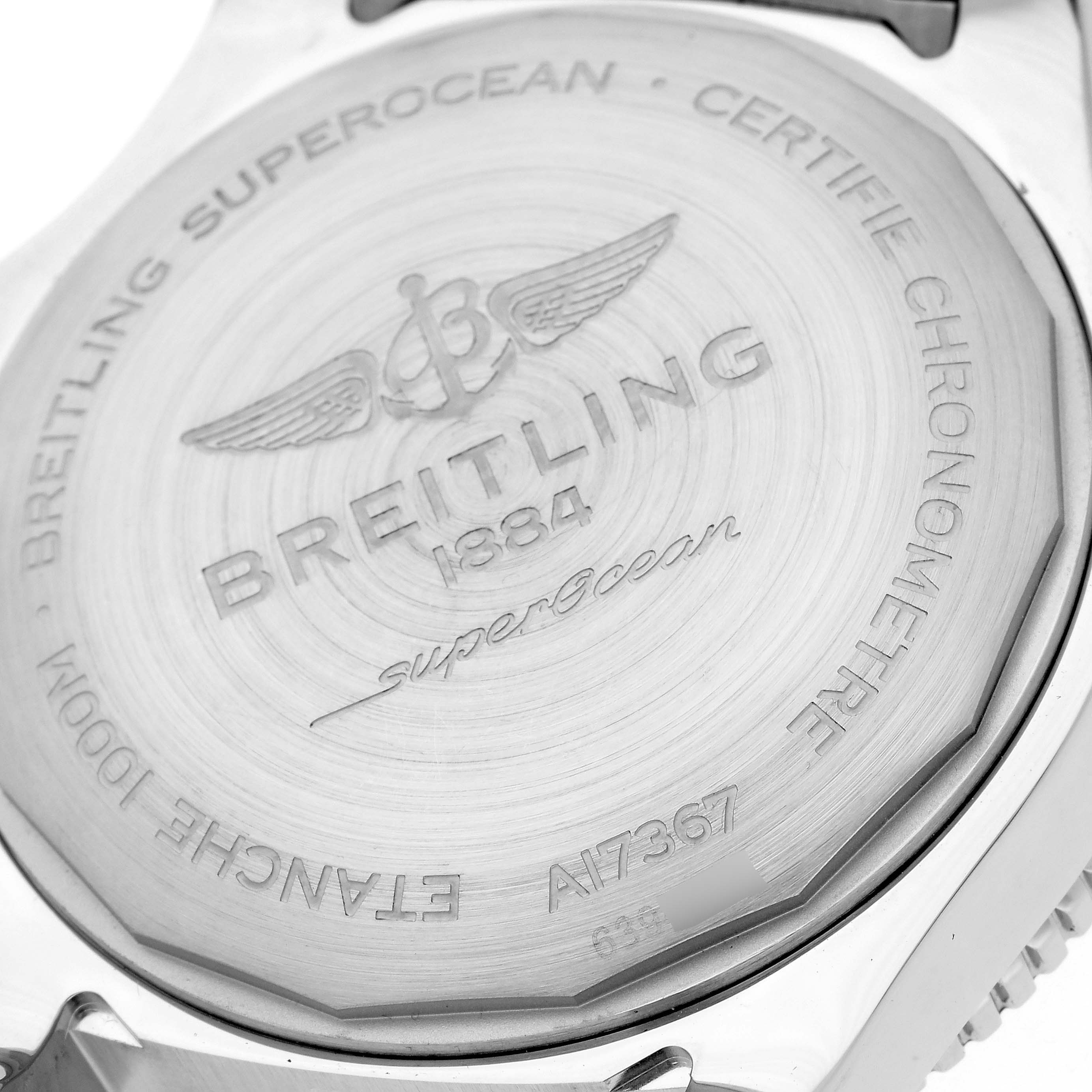 The image shows the back case of the Breitling Superocean A17367 Men
s Stainless Steel Yellow Dial A17367 Men
s Stainless Steel Yellow Dial watch, highlighting engravings and logo details.