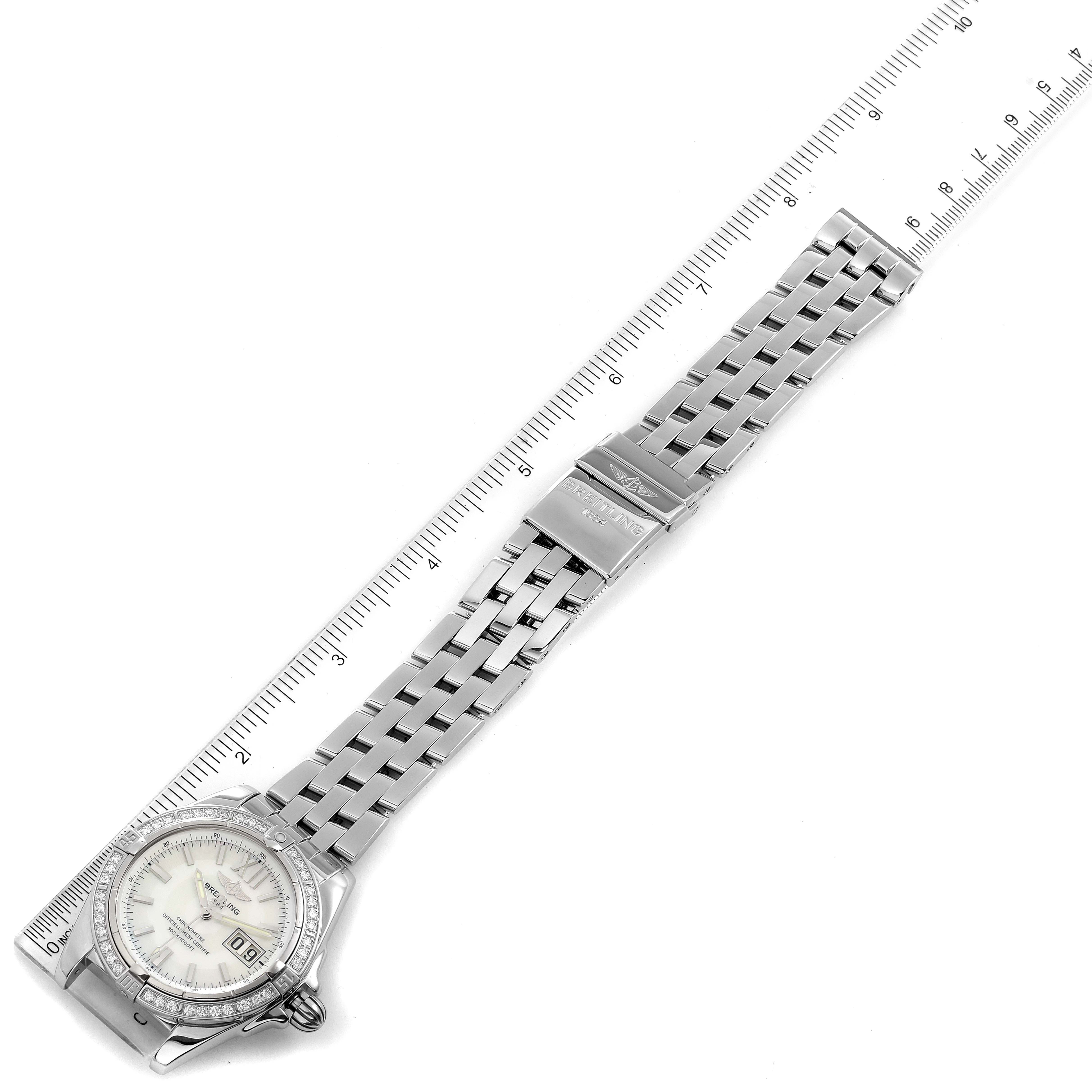 The Breitling Windrider A49350LA/A702-366A Men's Stainless Steel Mother of Pearl Dial A49350LA/A702-366A Men's Stainless Steel Mother of Pearl Dial watch is shot from an overhead angle, showing the full band and face, with a ruler beside it for scale.