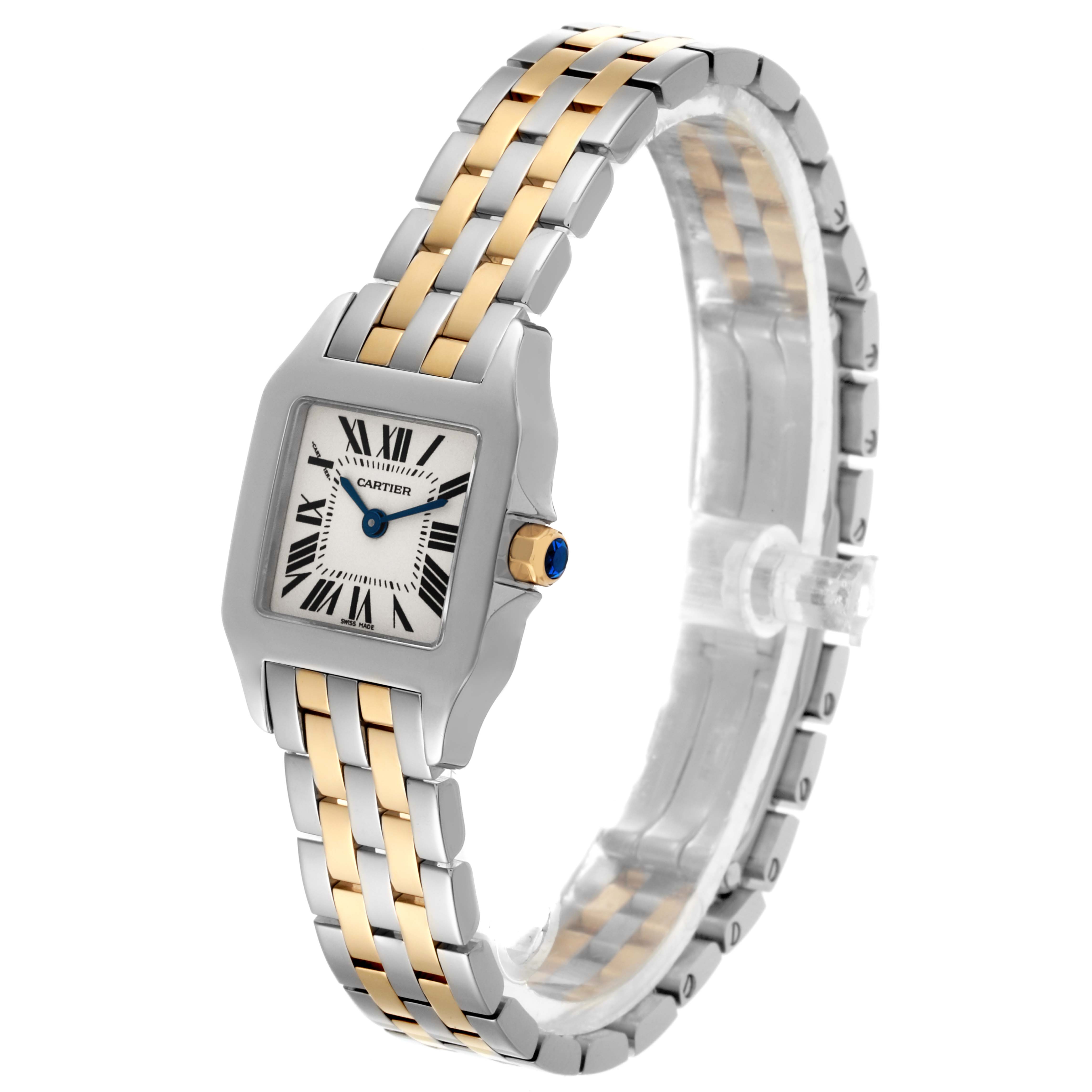The Cartier Santos Demoiselle W25066Z6 Women
s Steel and Gold (two tone) Silver Dial W25066Z6 Women
s Steel and Gold (two tone) Silver Dial watch is shown at an angle displaying the face, crown with a blue jewel, and two-tone bracelet.