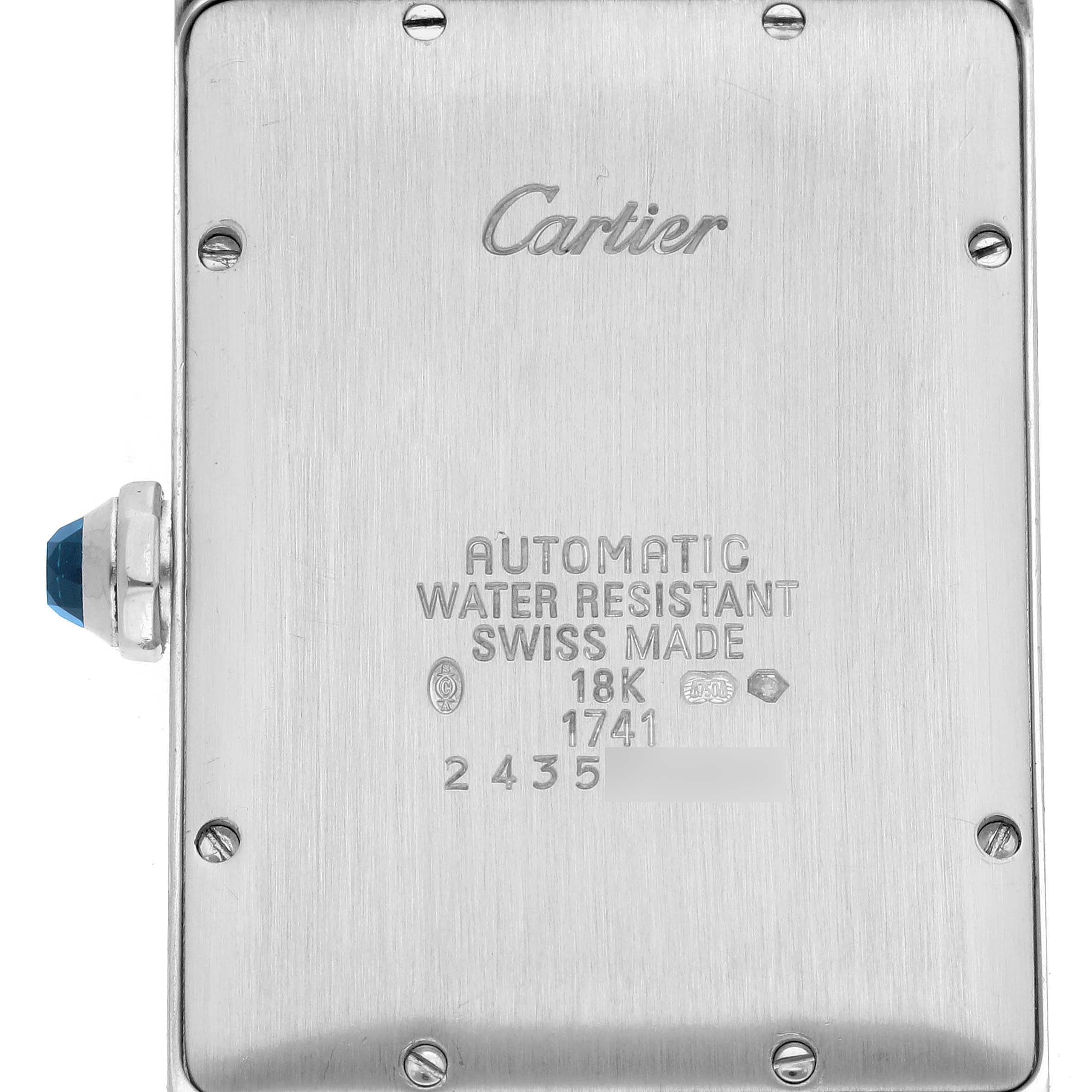 The image shows the back of the Cartier Tank Americaine W2603256 Men's White Gold Silver Dial W2603256 Men's White Gold Silver Dial watch, displaying the branding, specifications, and crown with a cabochon.