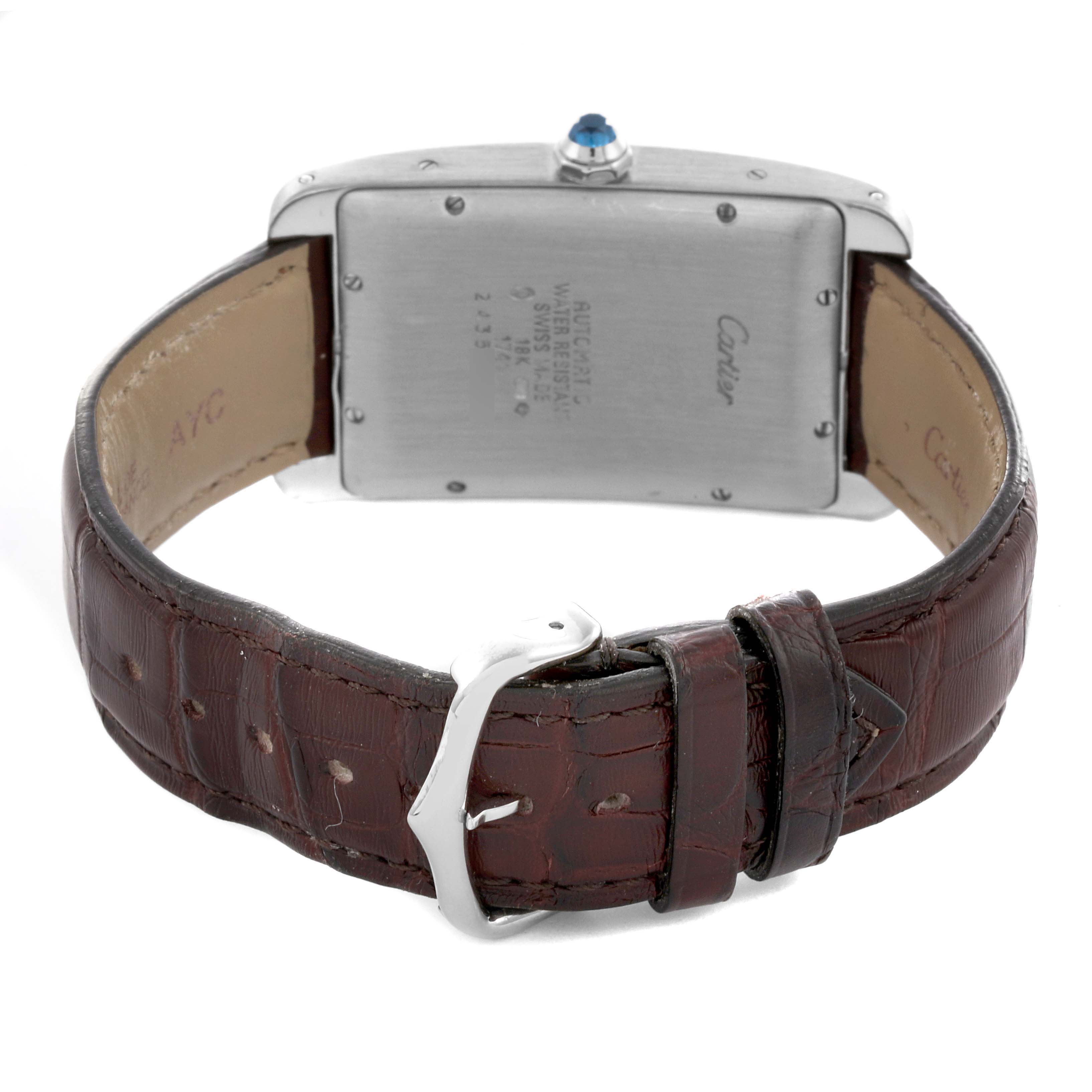 The image shows the back view of a Cartier Tank Américaine watch, highlighting the case back and leather strap with buckle.