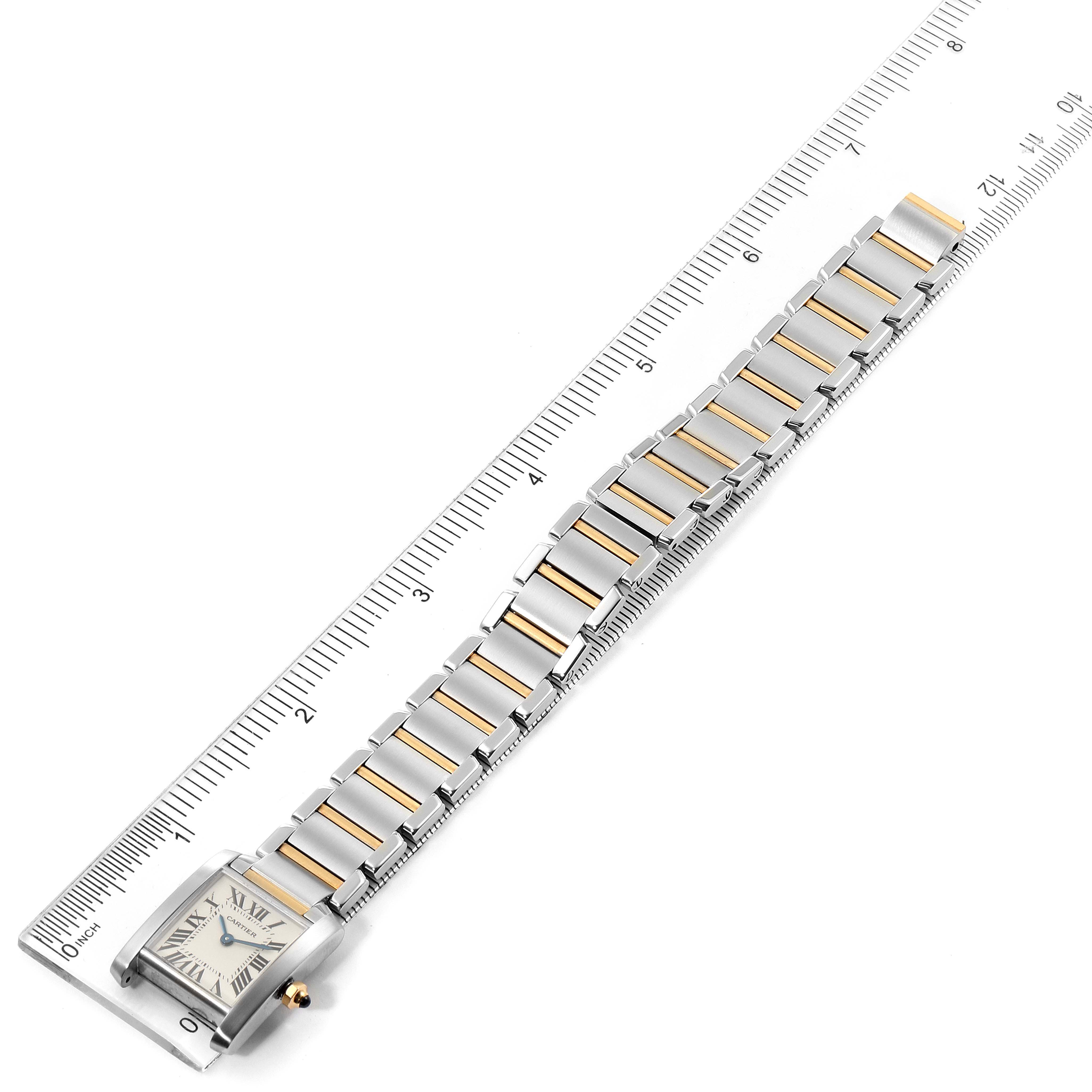 The image shows a Cartier Tank Francaise W51007Q4 Women's Steel and Gold (two tone) Silver Dial W51007Q4 Women's Steel and Gold (two tone) Silver Dial watch laid out flat against a ruler, highlighting its face and bracelet.