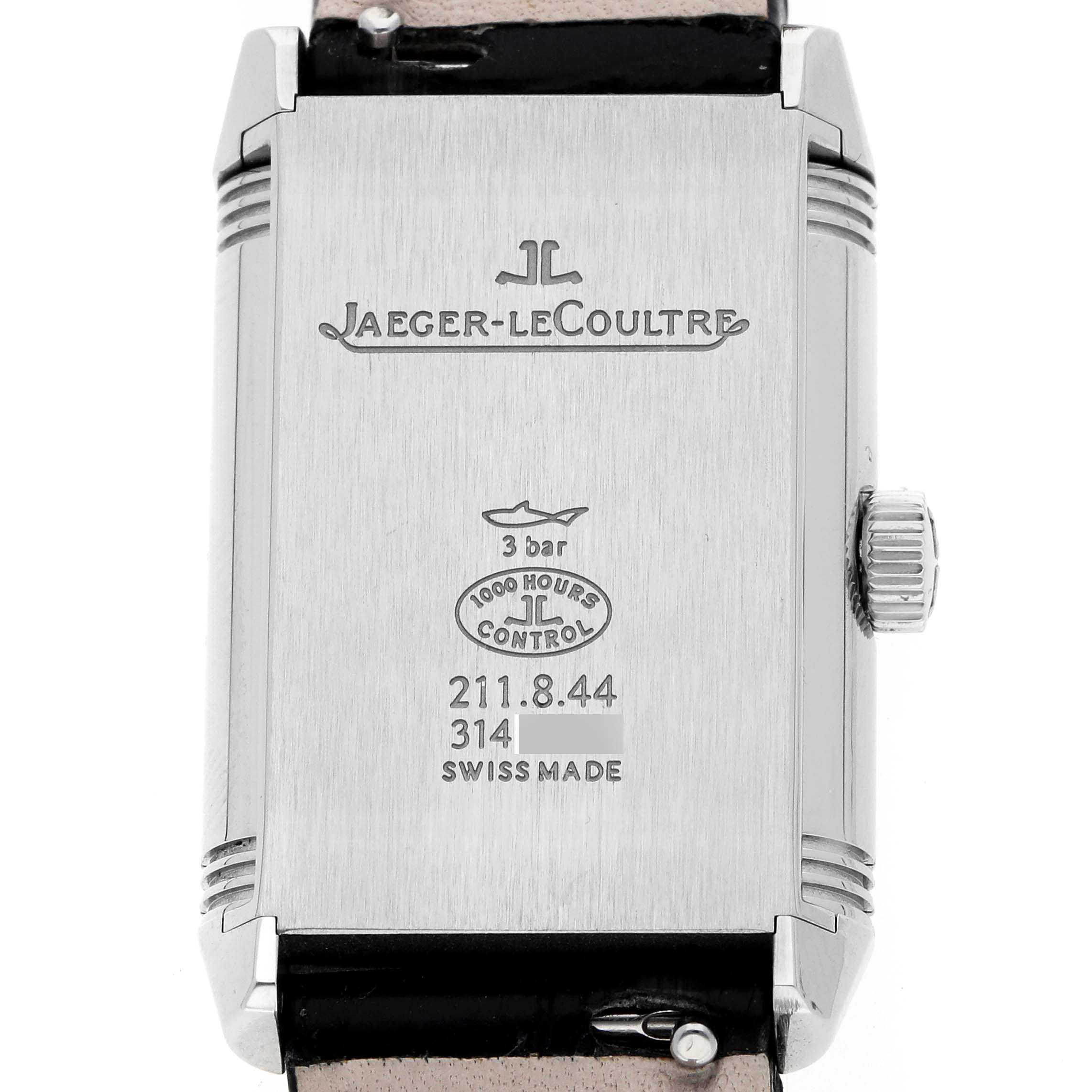 The image shows the back of a Jaeger-LeCoultre Reverso watch, highlighting the brand logo, markings, and crown.