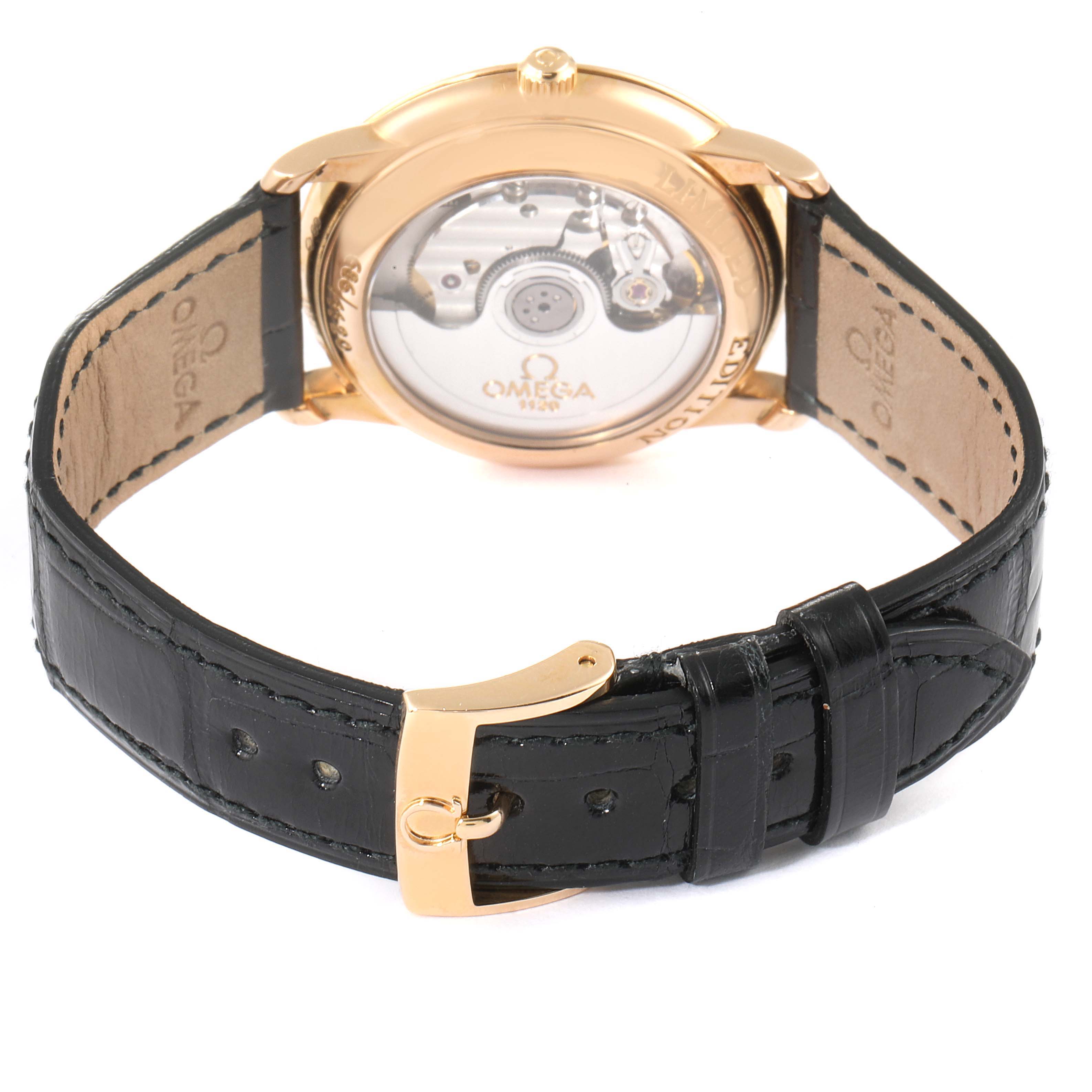 The image shows the back view of an Omega De Ville 4601.54.11 Men's Rose Gold Black Dial 4601.54.11 Men's Rose Gold Black Dial watch, focusing on the transparent case back and leather strap with a buckle.